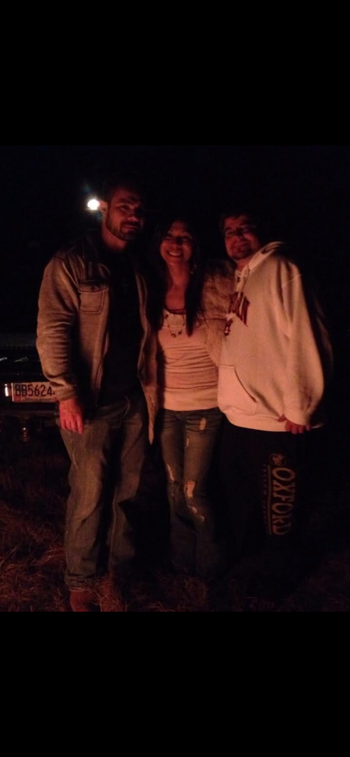 A group of people standing together at night