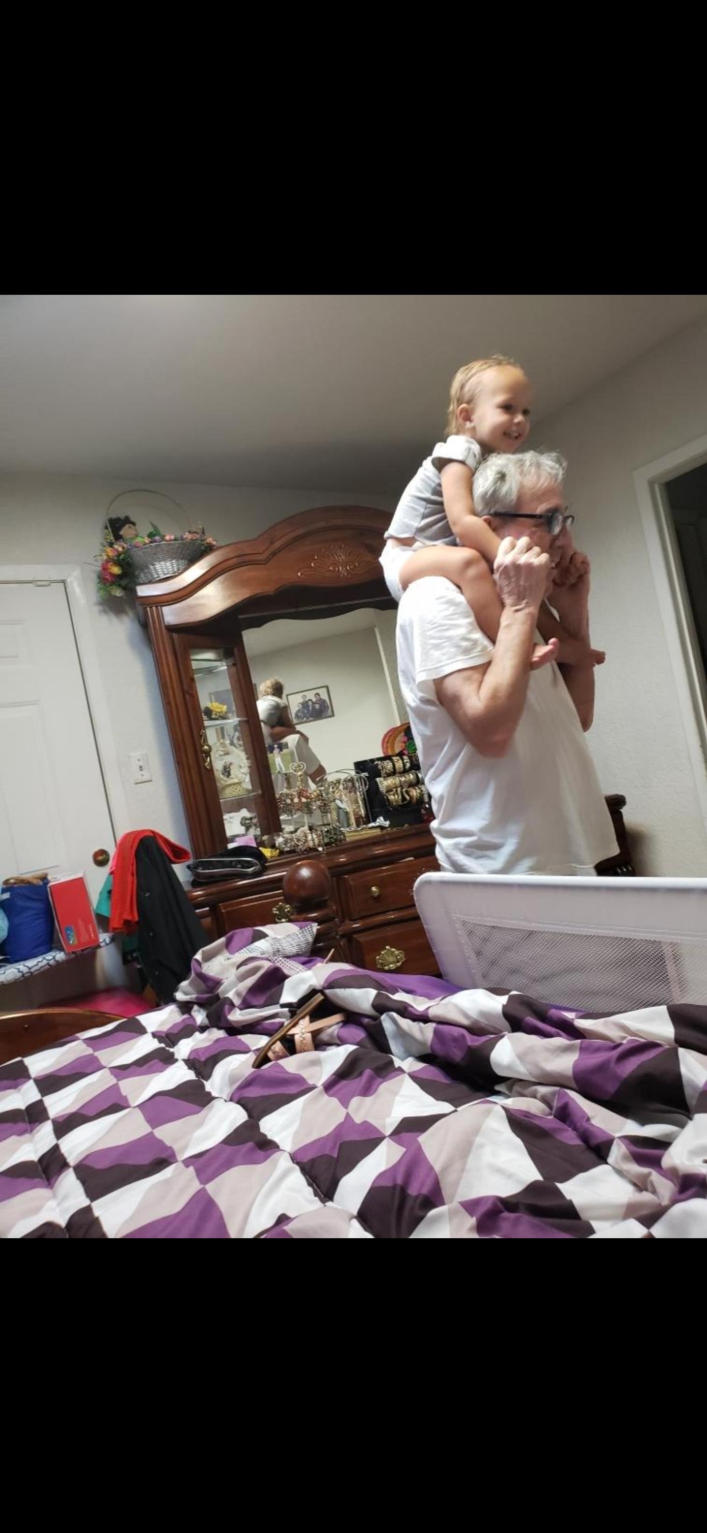 A man carrying a child on his shoulders