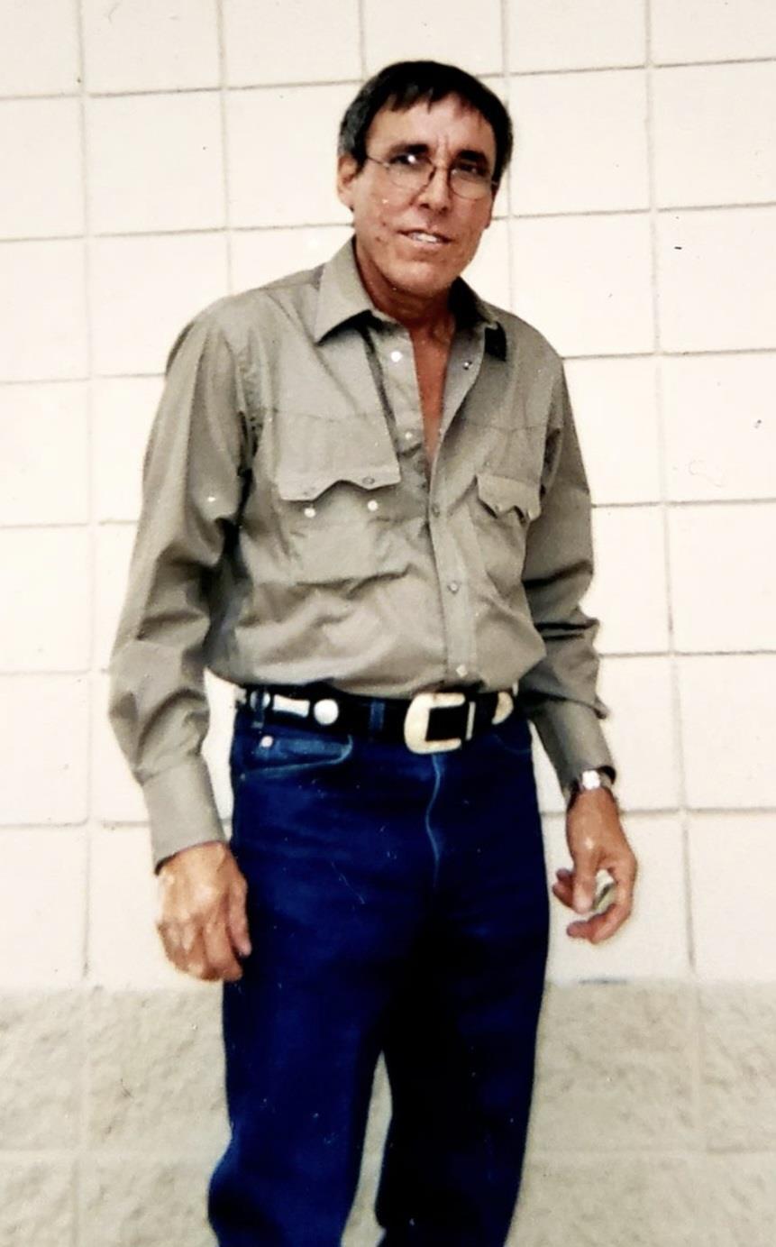 A man wearing a hat and a green shirt