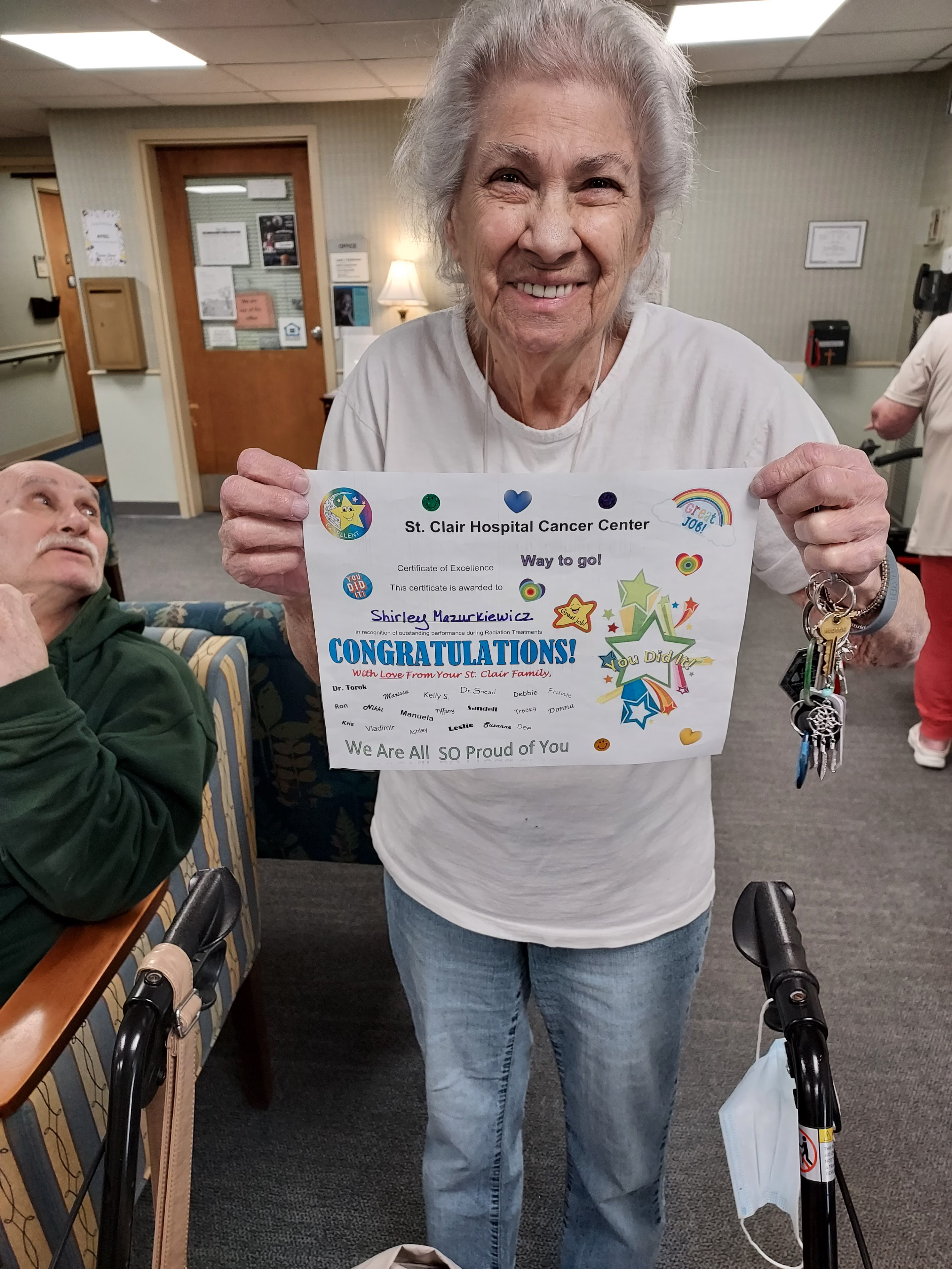 A woman holding a sign with keys