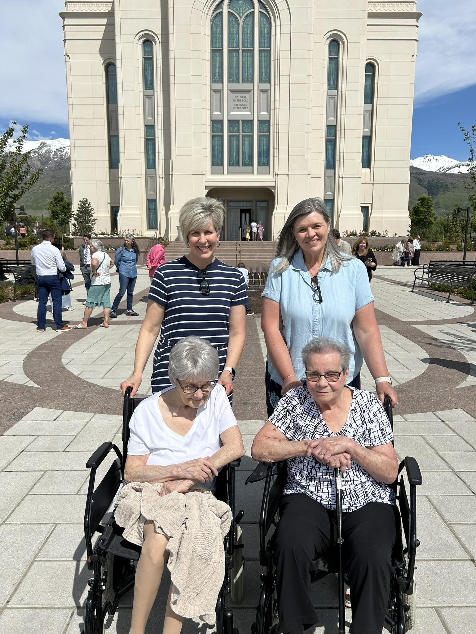 A group of women in wheelchairs outside of a building