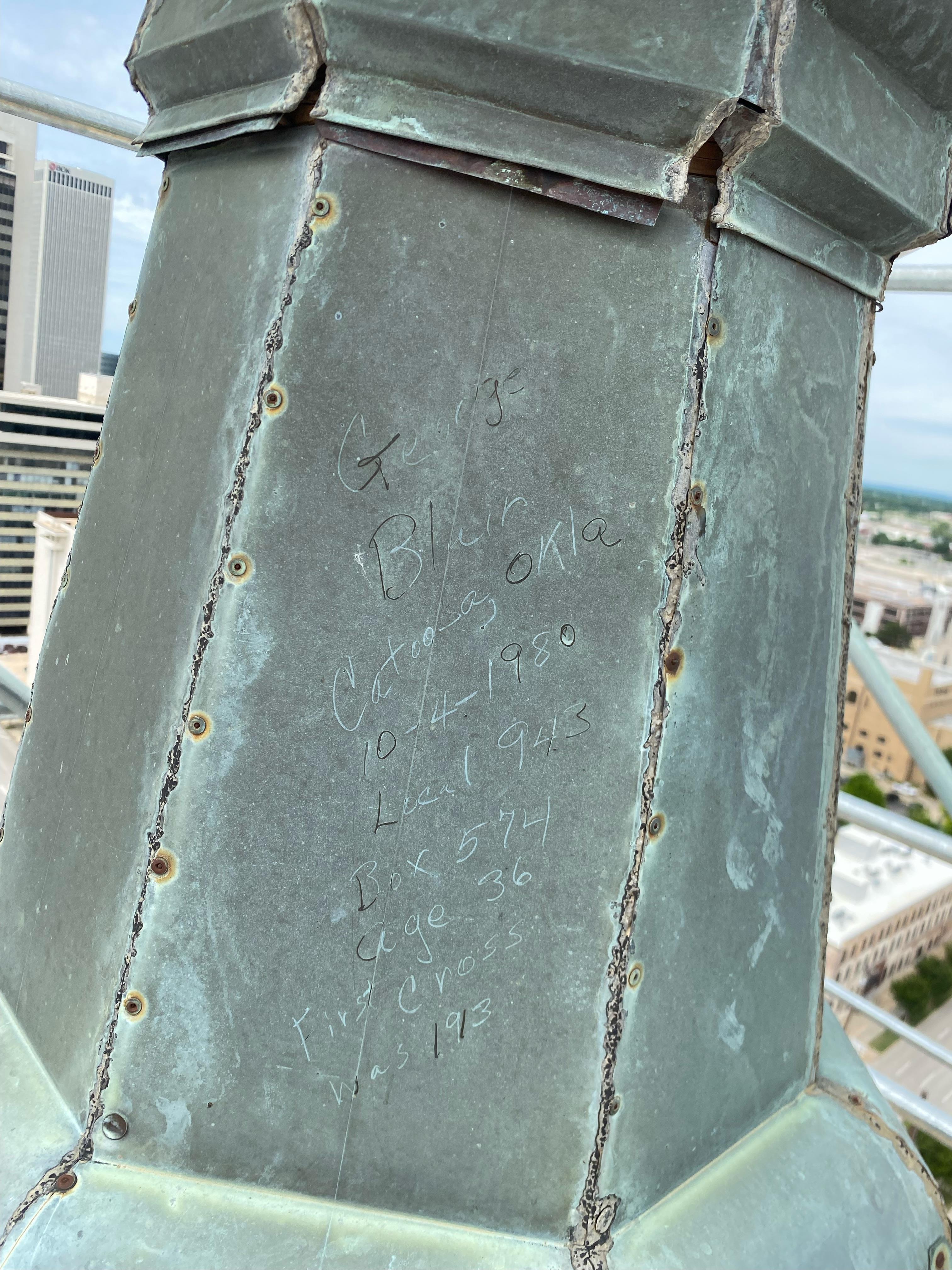 A metal tower with writing on it