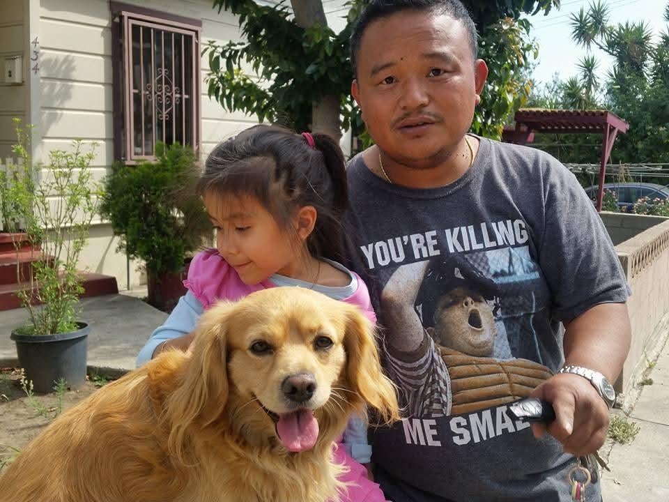 A man and a girl with a dog