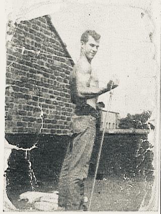 A man standing in front of a brick building