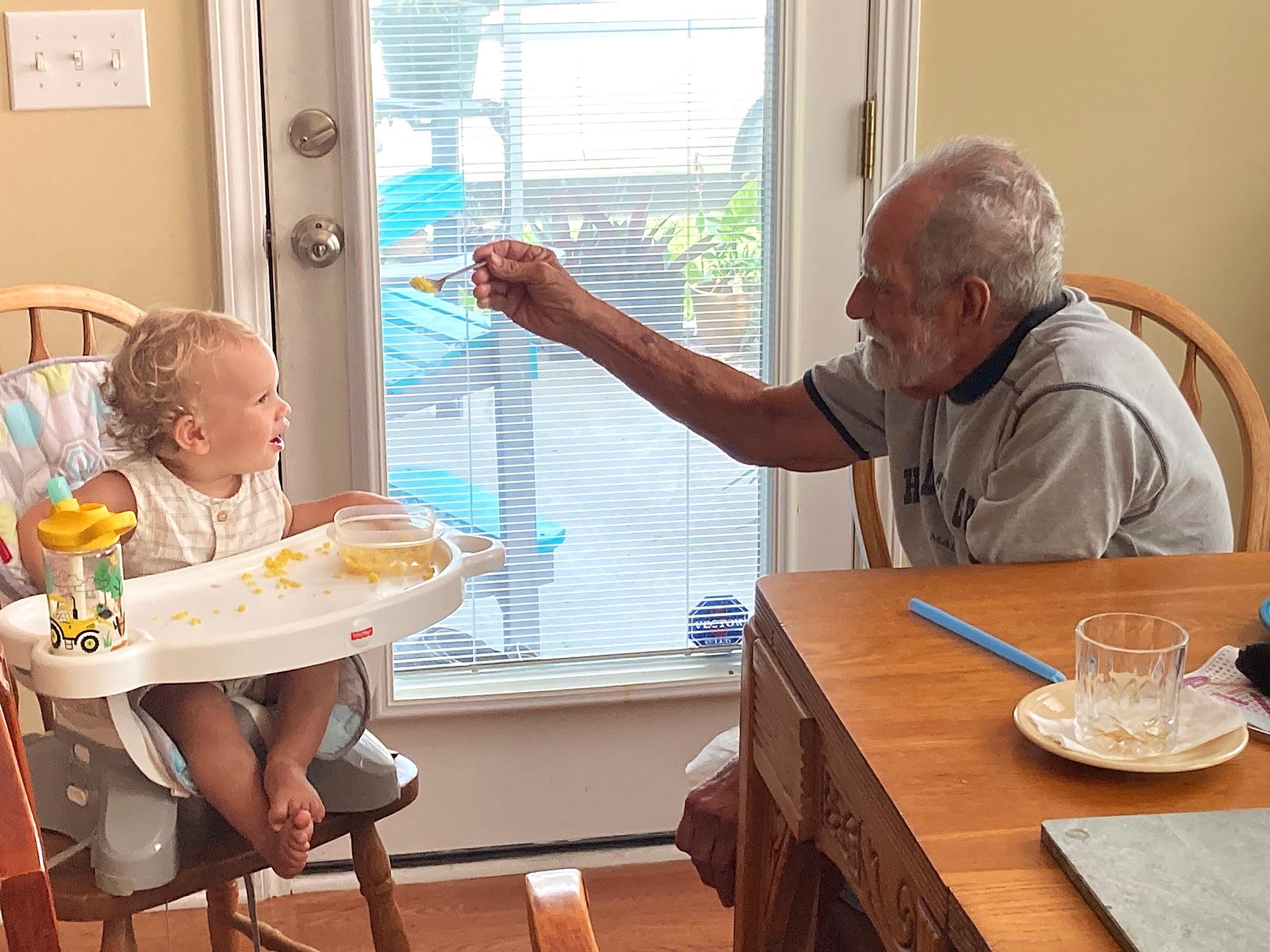 A man feeding a baby