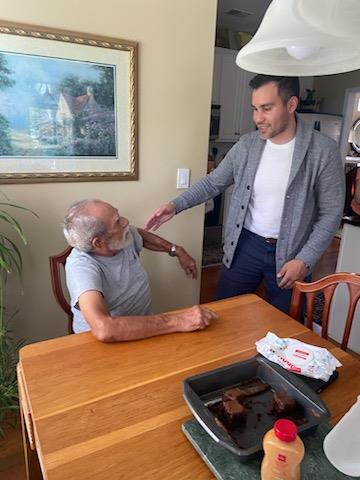 A man standing next to an old man