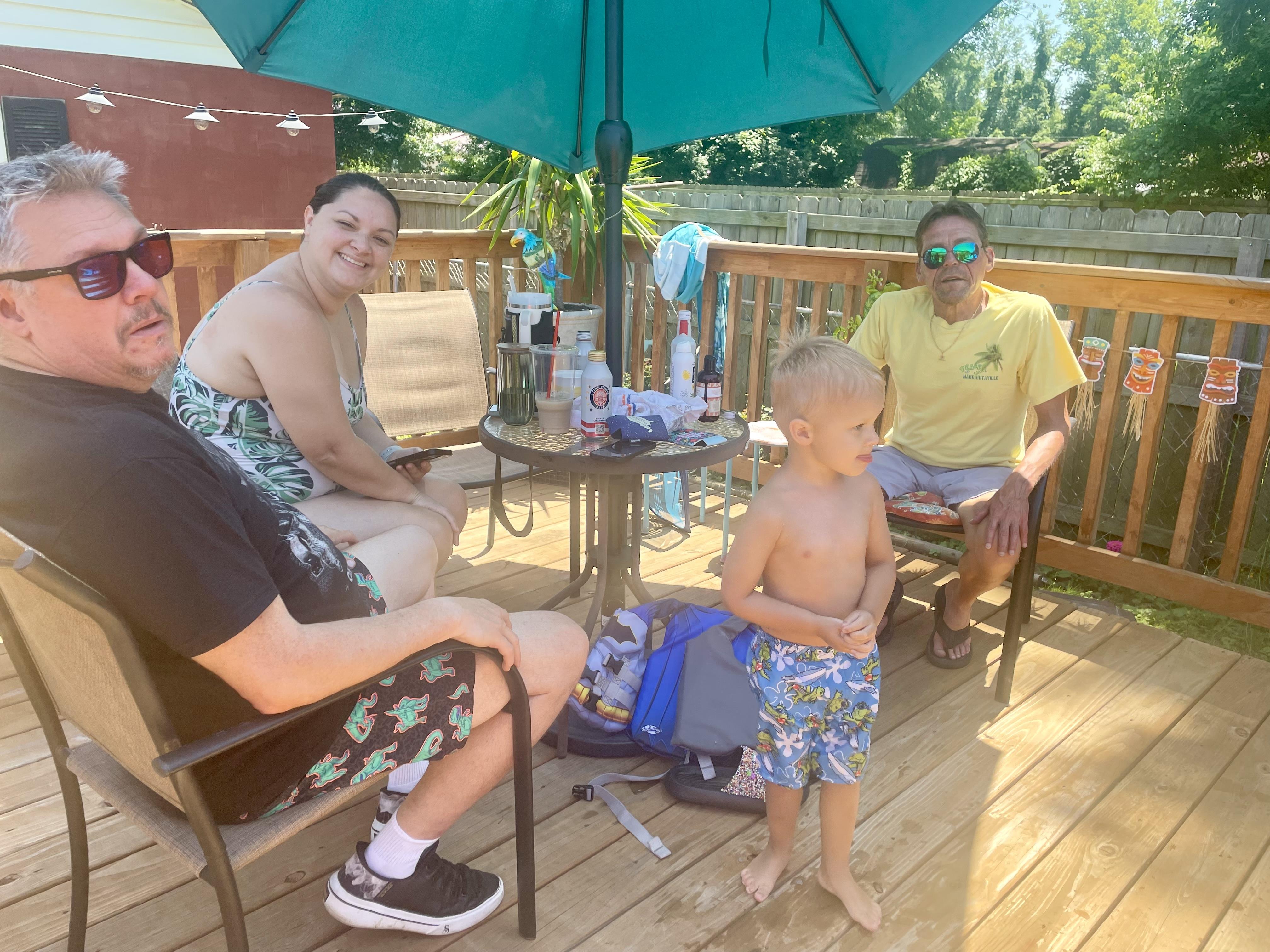 A group of people sitting on a deck