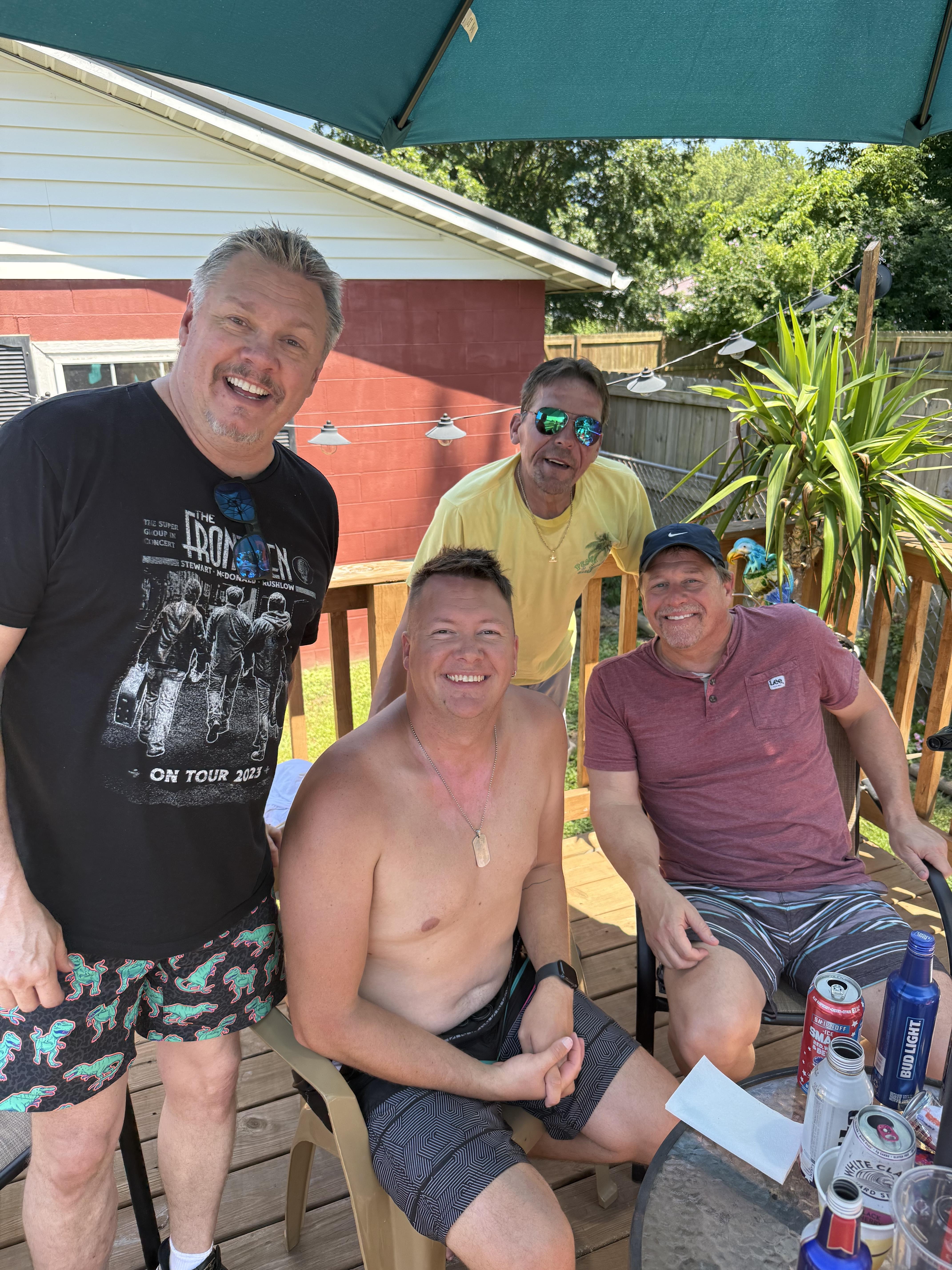 A group of men sitting on chairs outside