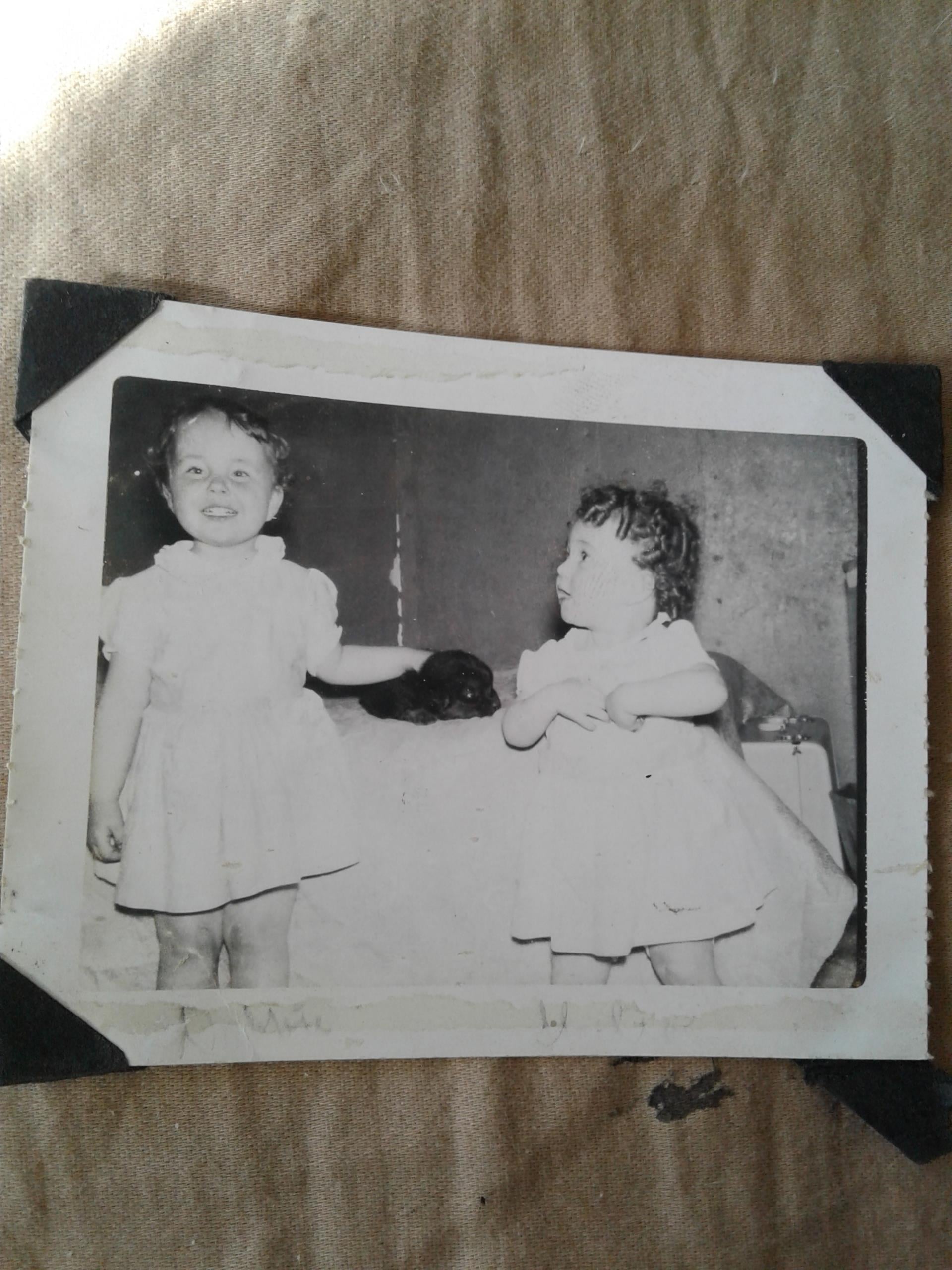 A black and white photo of two girls
