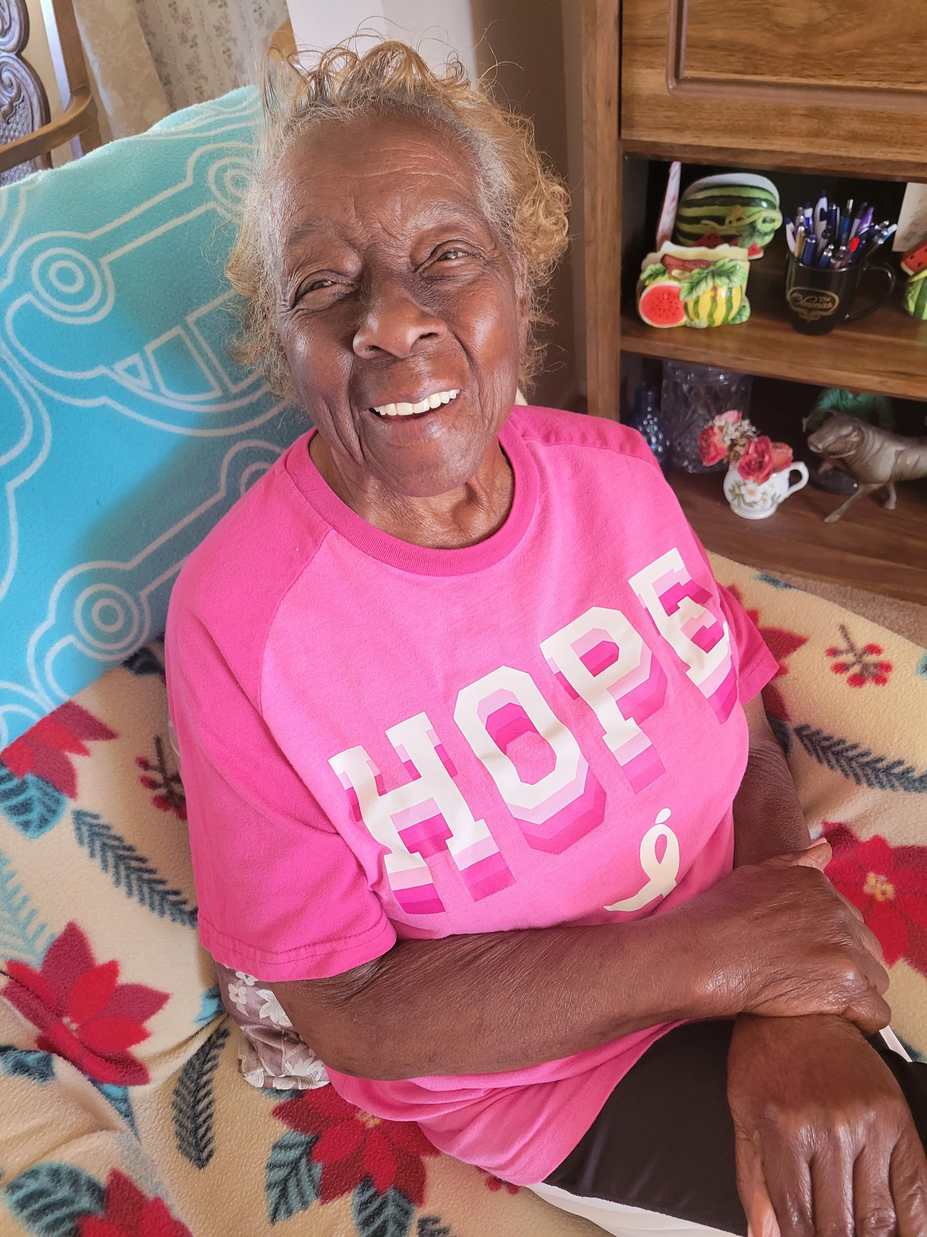 A woman sitting on a bed smiling
