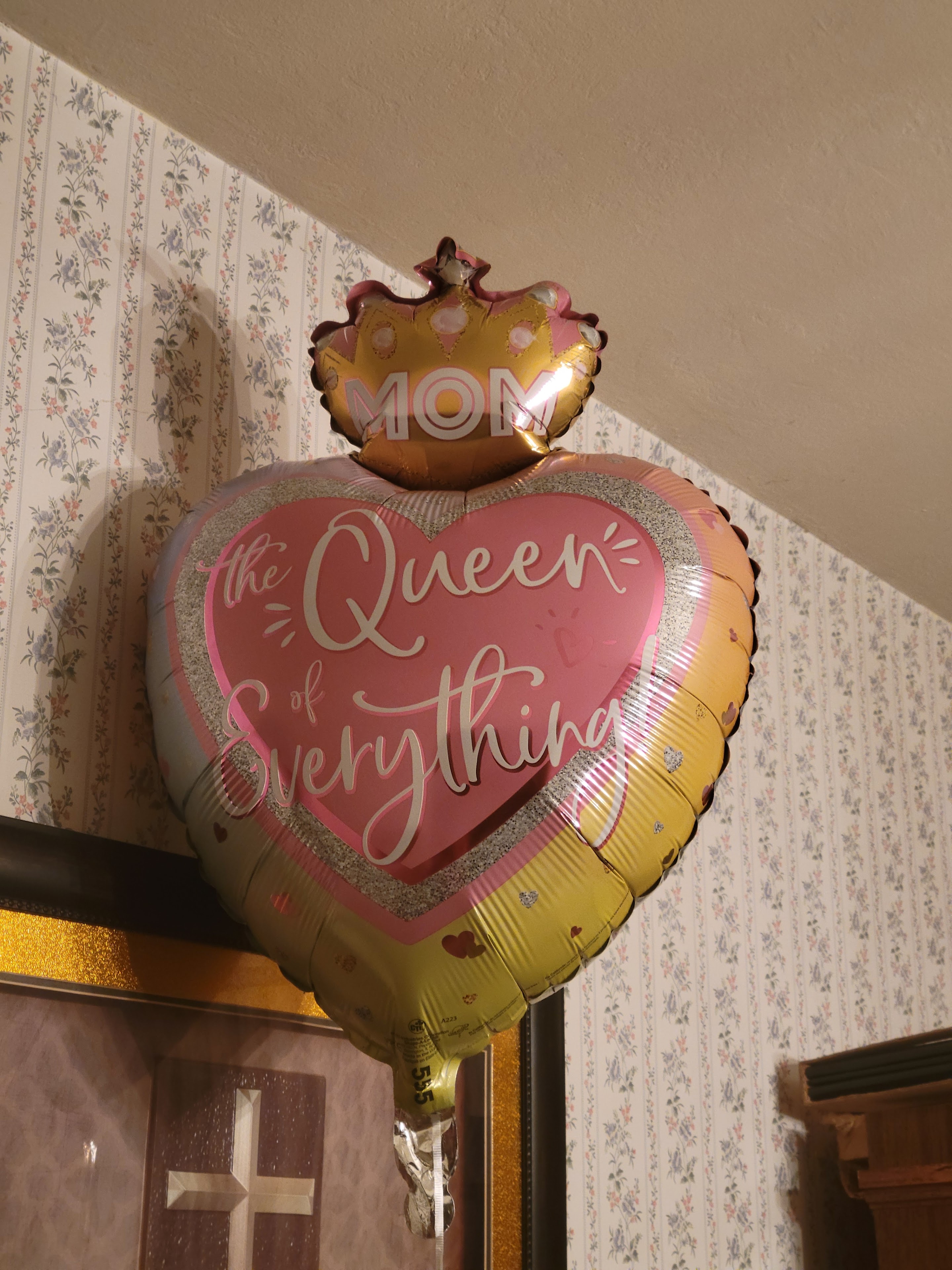 A heart shaped balloon with a crown and a crown on top