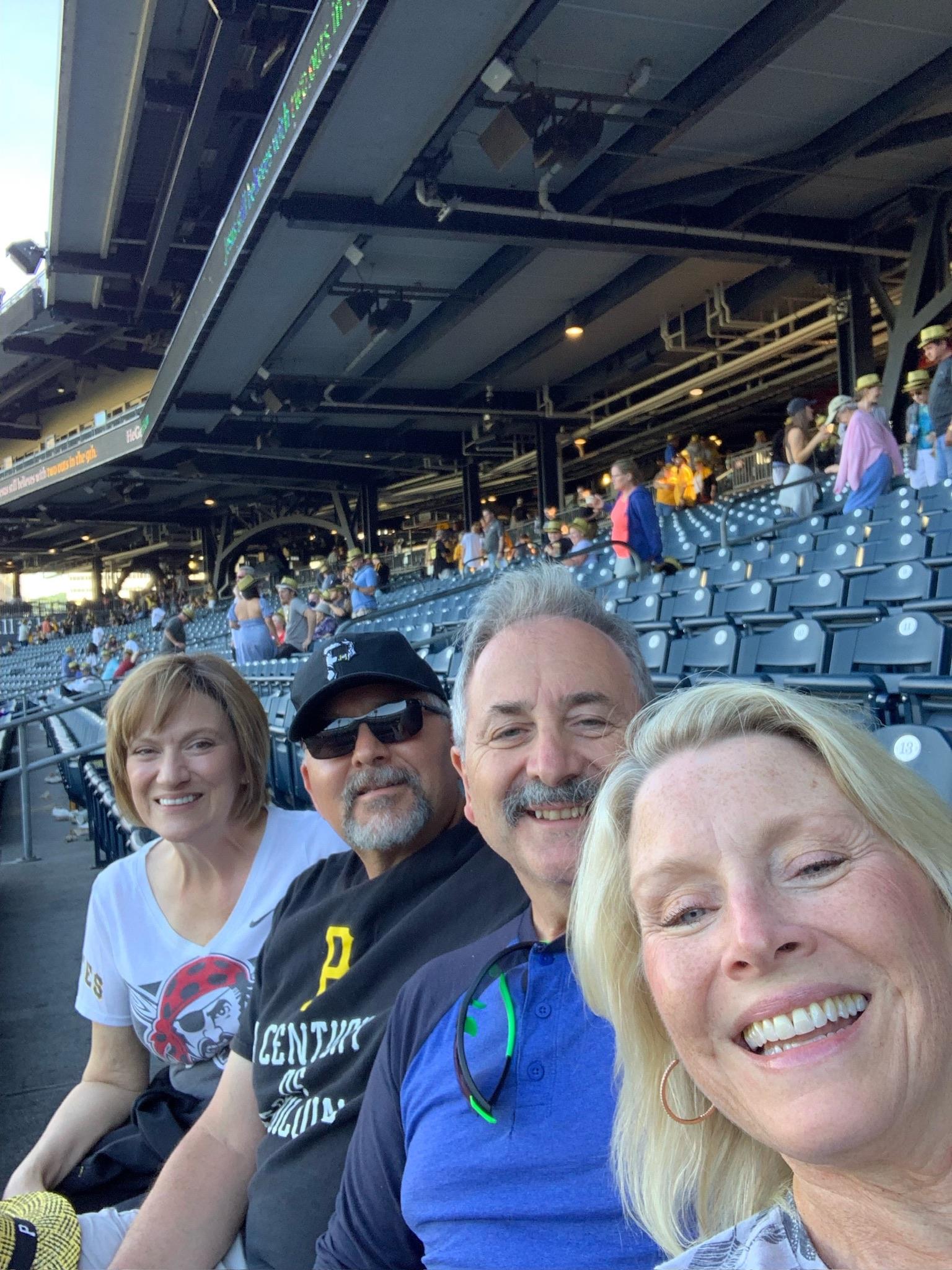 A group of people taking a selfie in a stadium