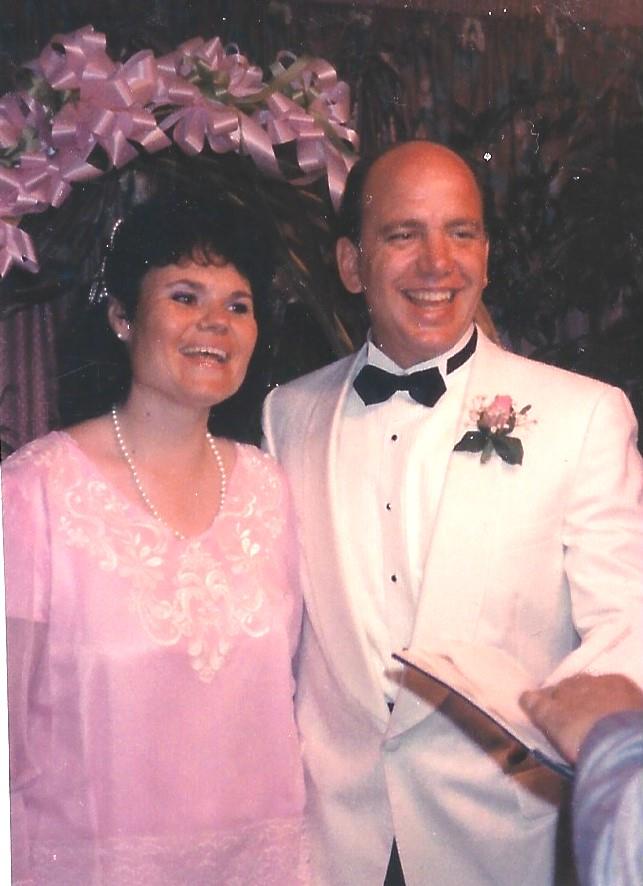 A man and woman smiling at the camera