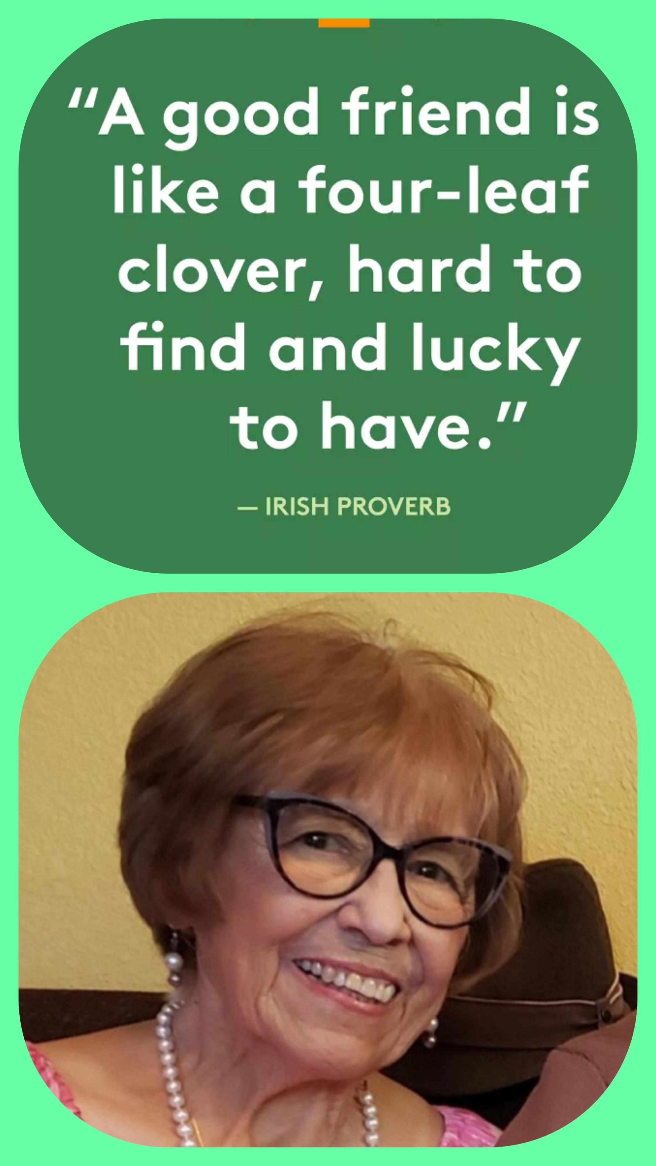A woman with red hair wearing glasses