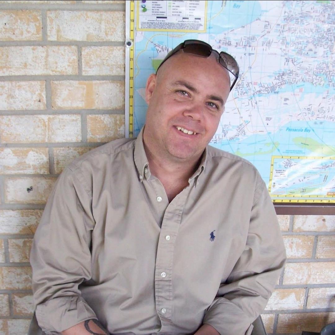 A man sitting in front of a map