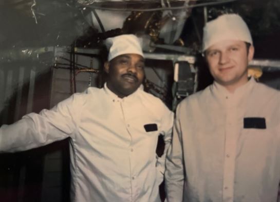 Two men wearing white hats and white shirts