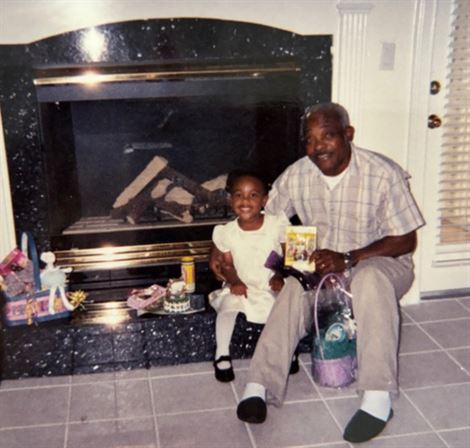 A man and child sitting in front of a fireplace