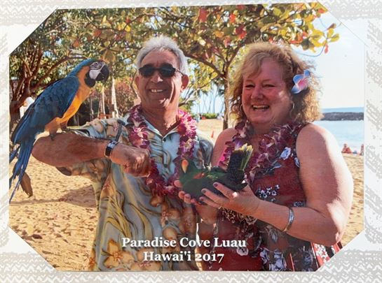 A man and woman holding birds