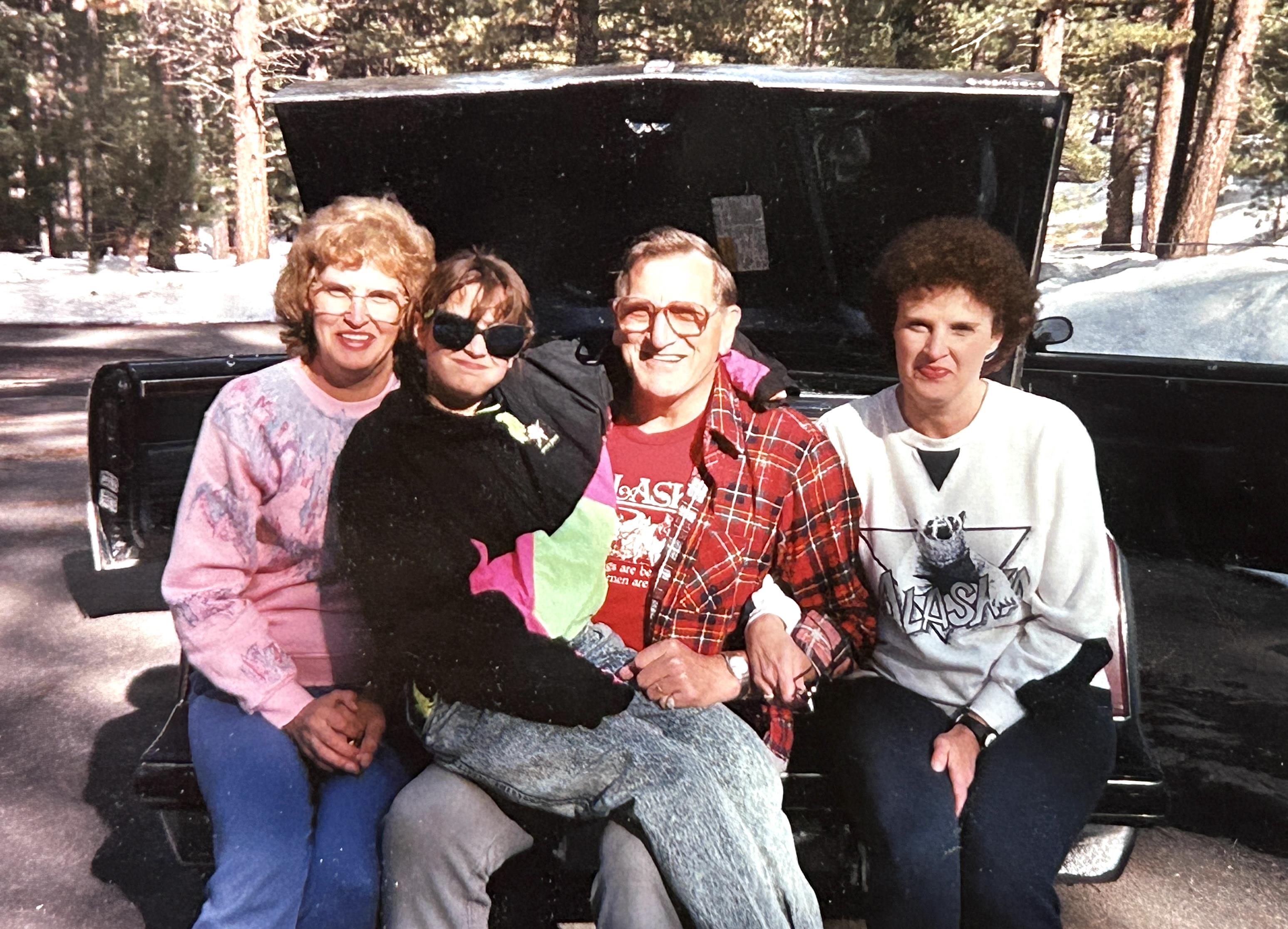 A group of people sitting in the back of a car
