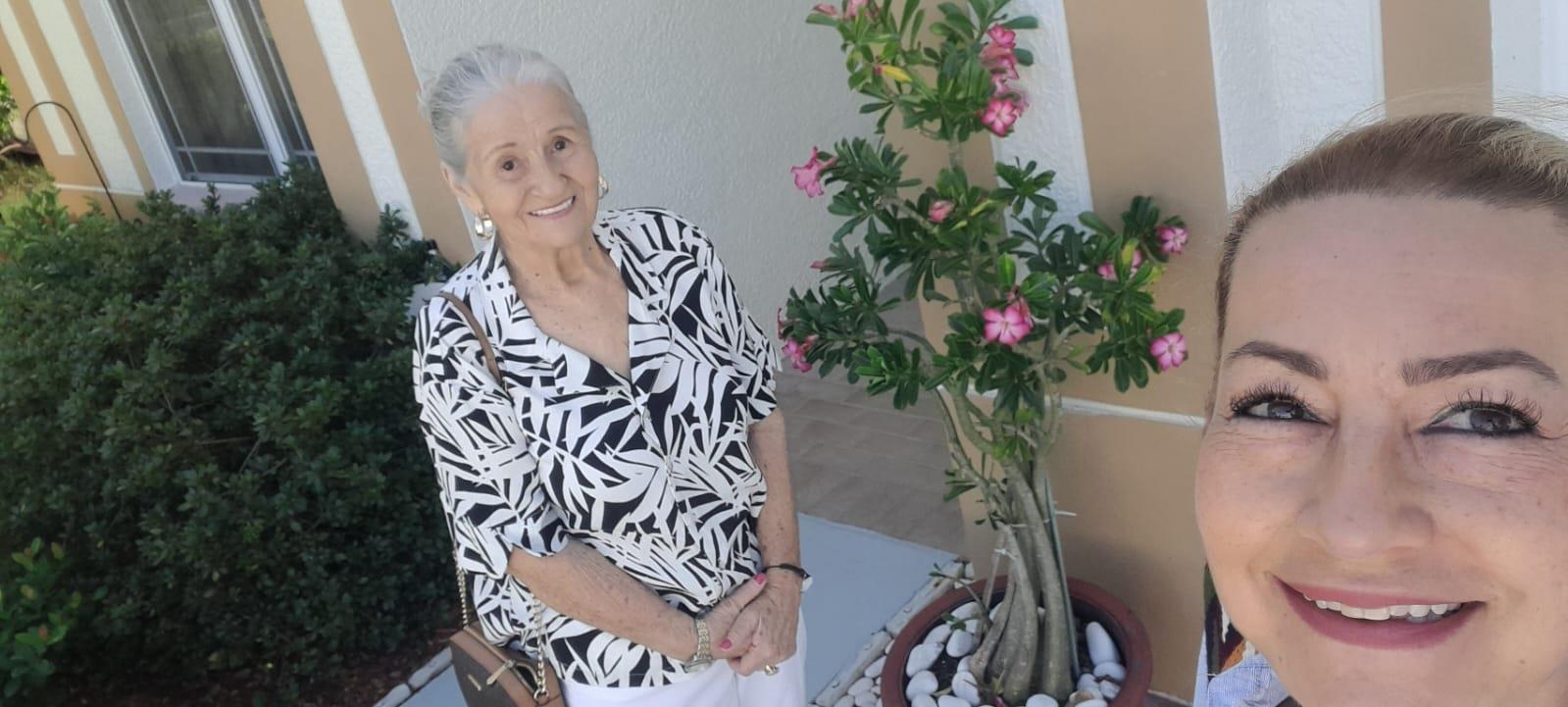 A woman standing next to a plant