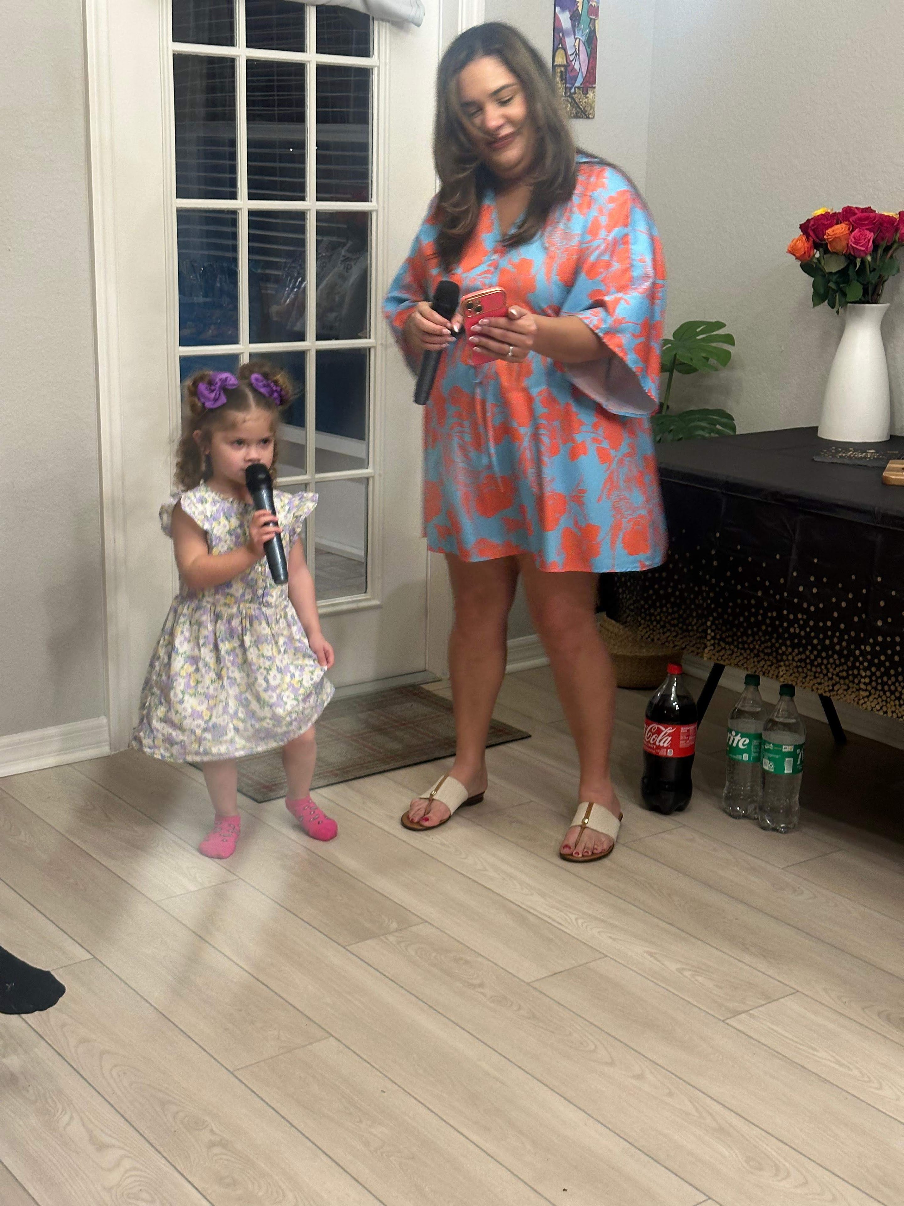 A woman and a girl holding microphones