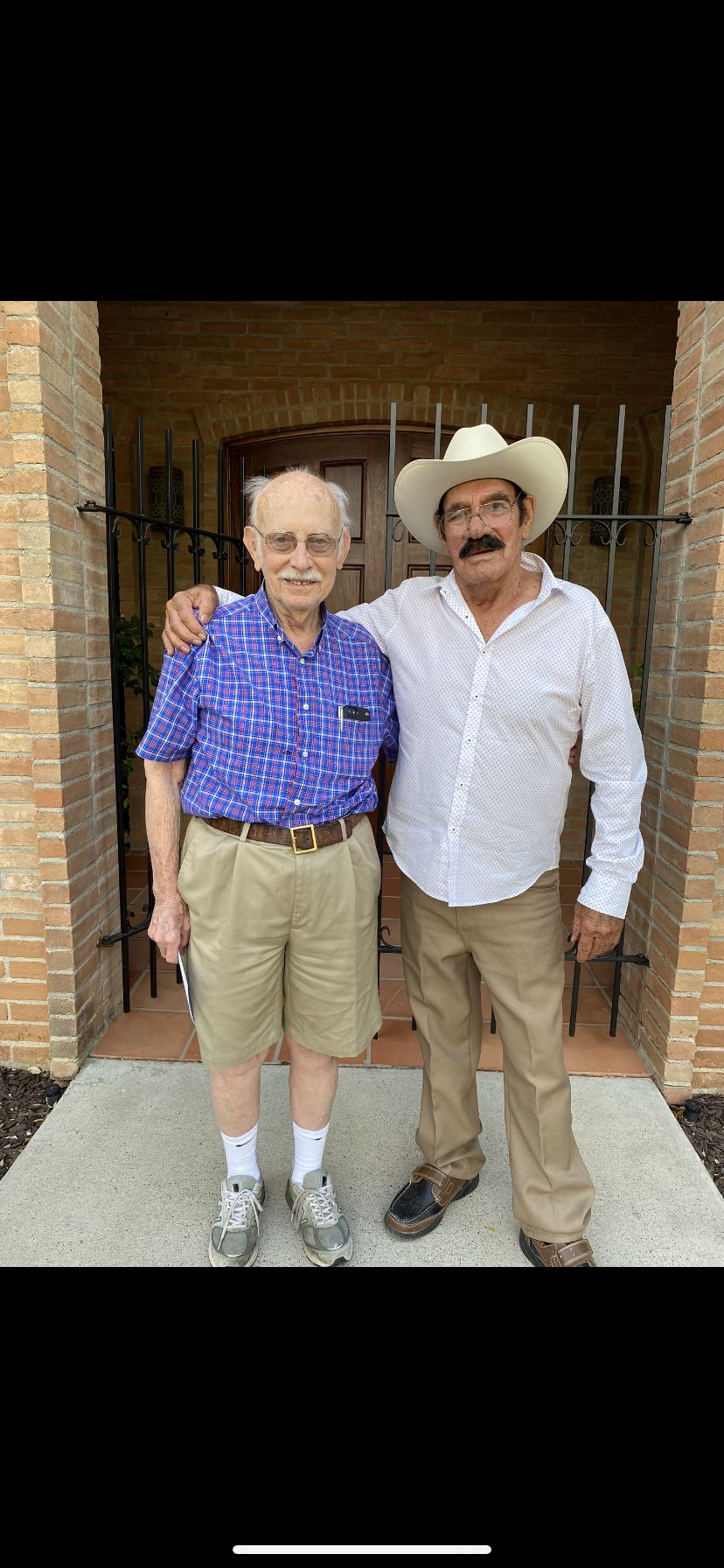 Two men standing in front of a door
