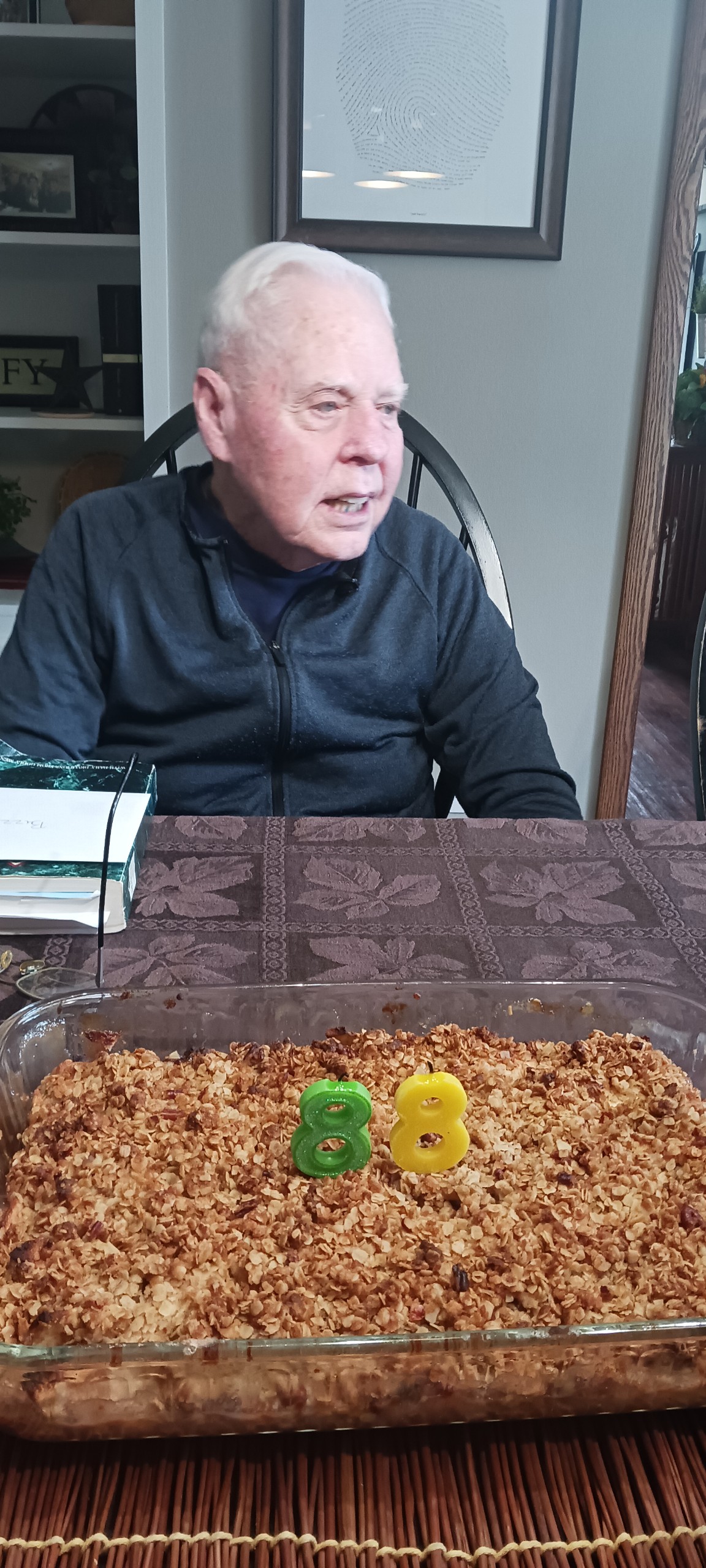A man sitting in a chair with a cake