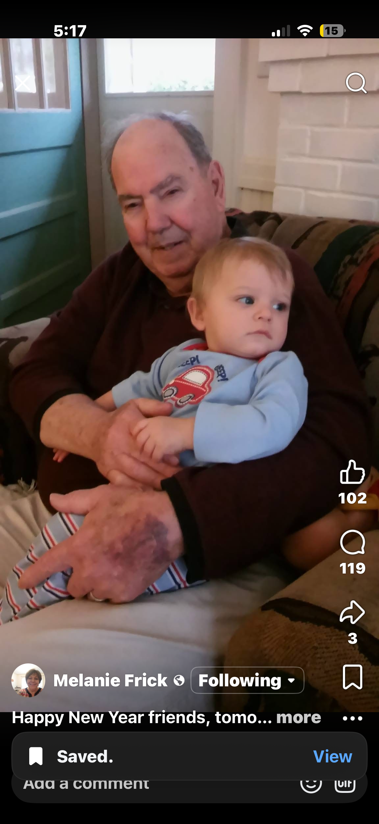 An old man holding a baby