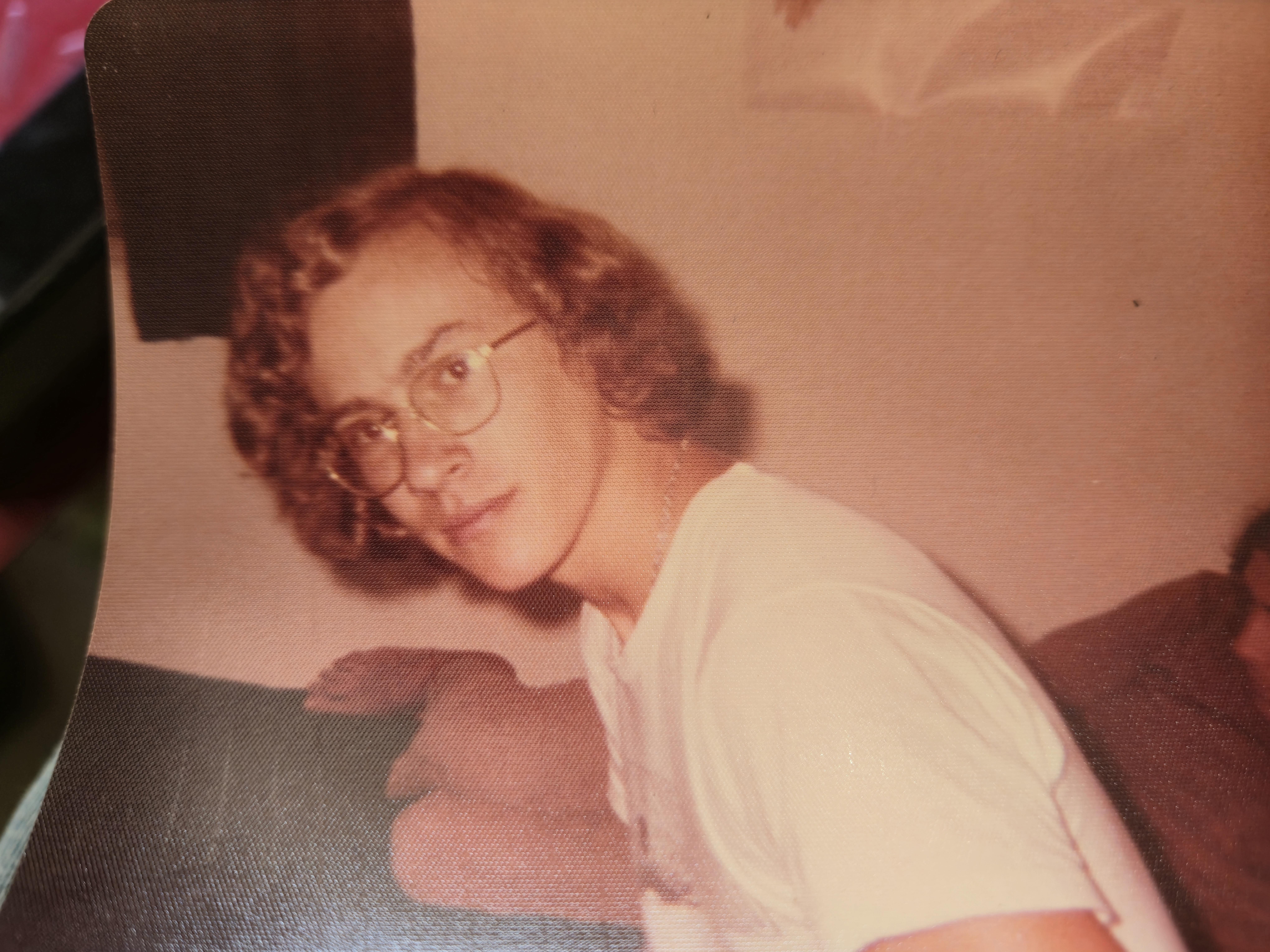 A man with curly hair wearing glasses
