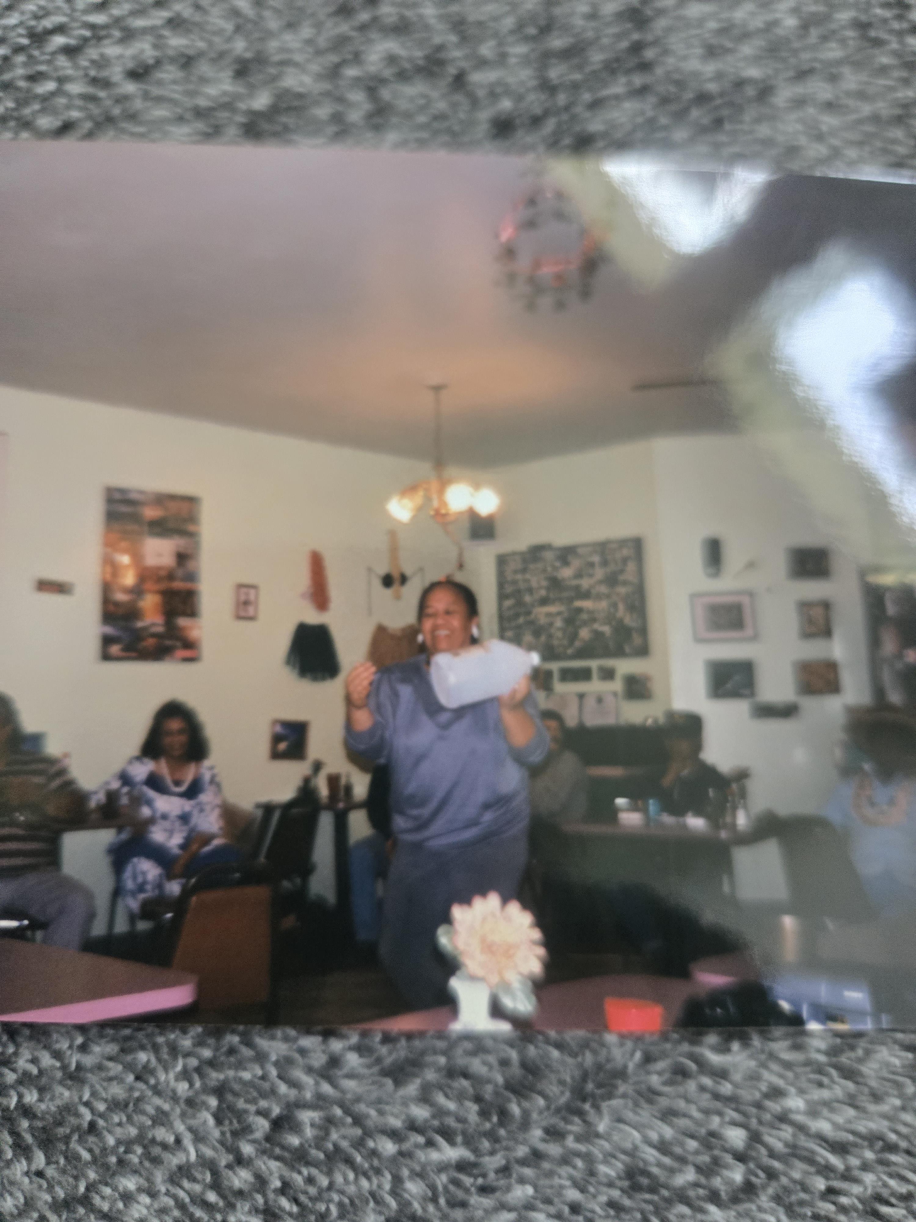 A woman holding a pillow in a room