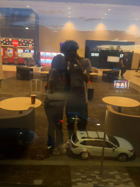 A couple of people taking a selfie in a mall