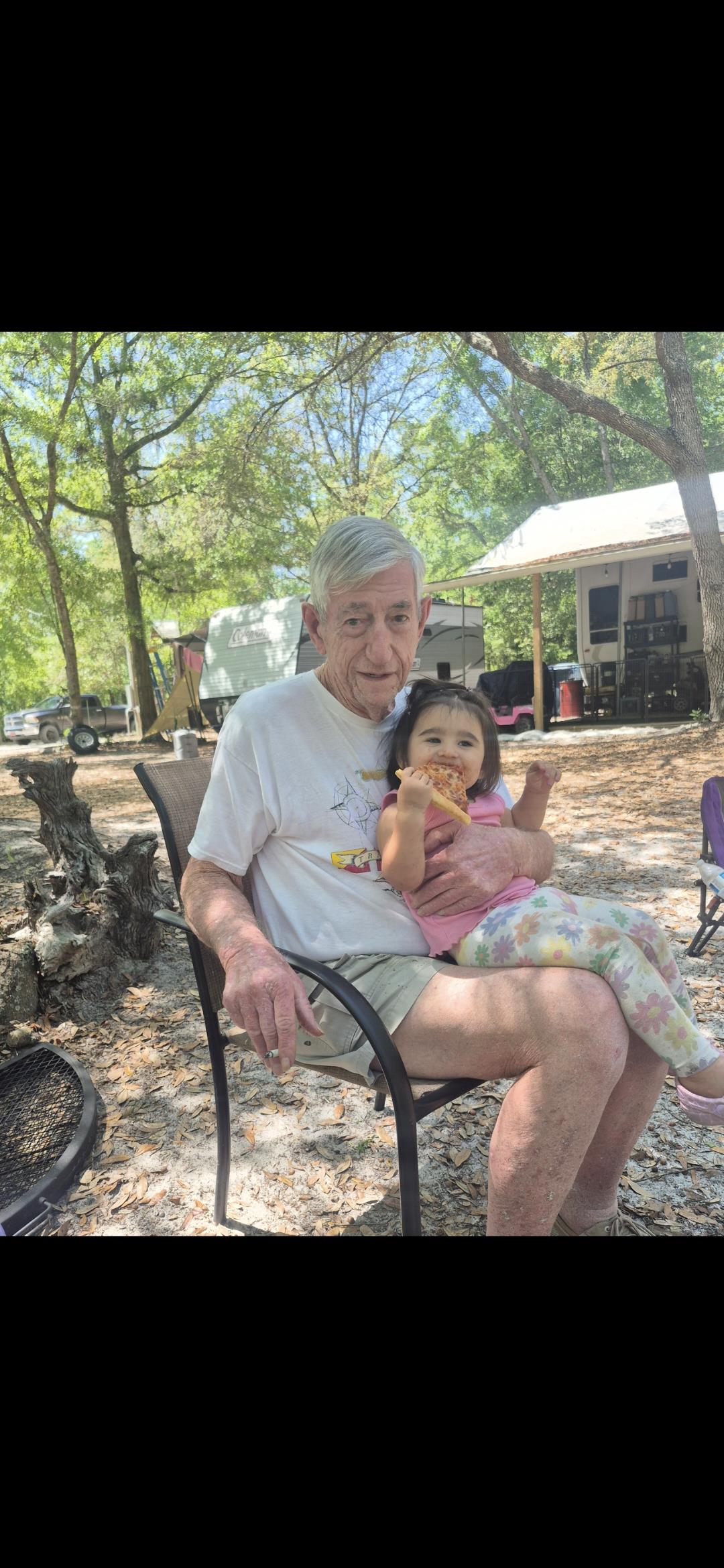 An old man holding a young girl