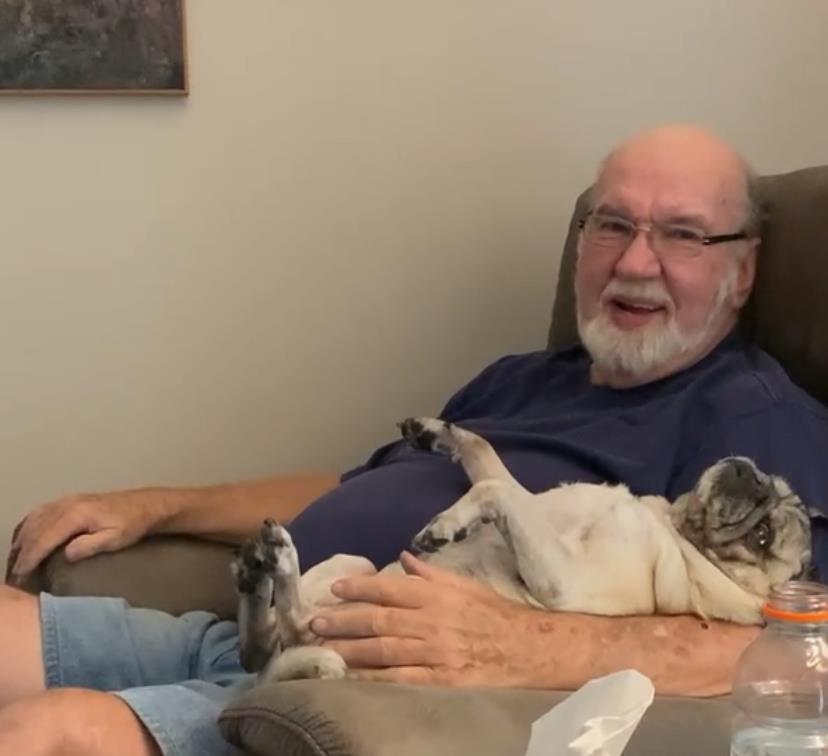 A man sitting in a chair with a dog
