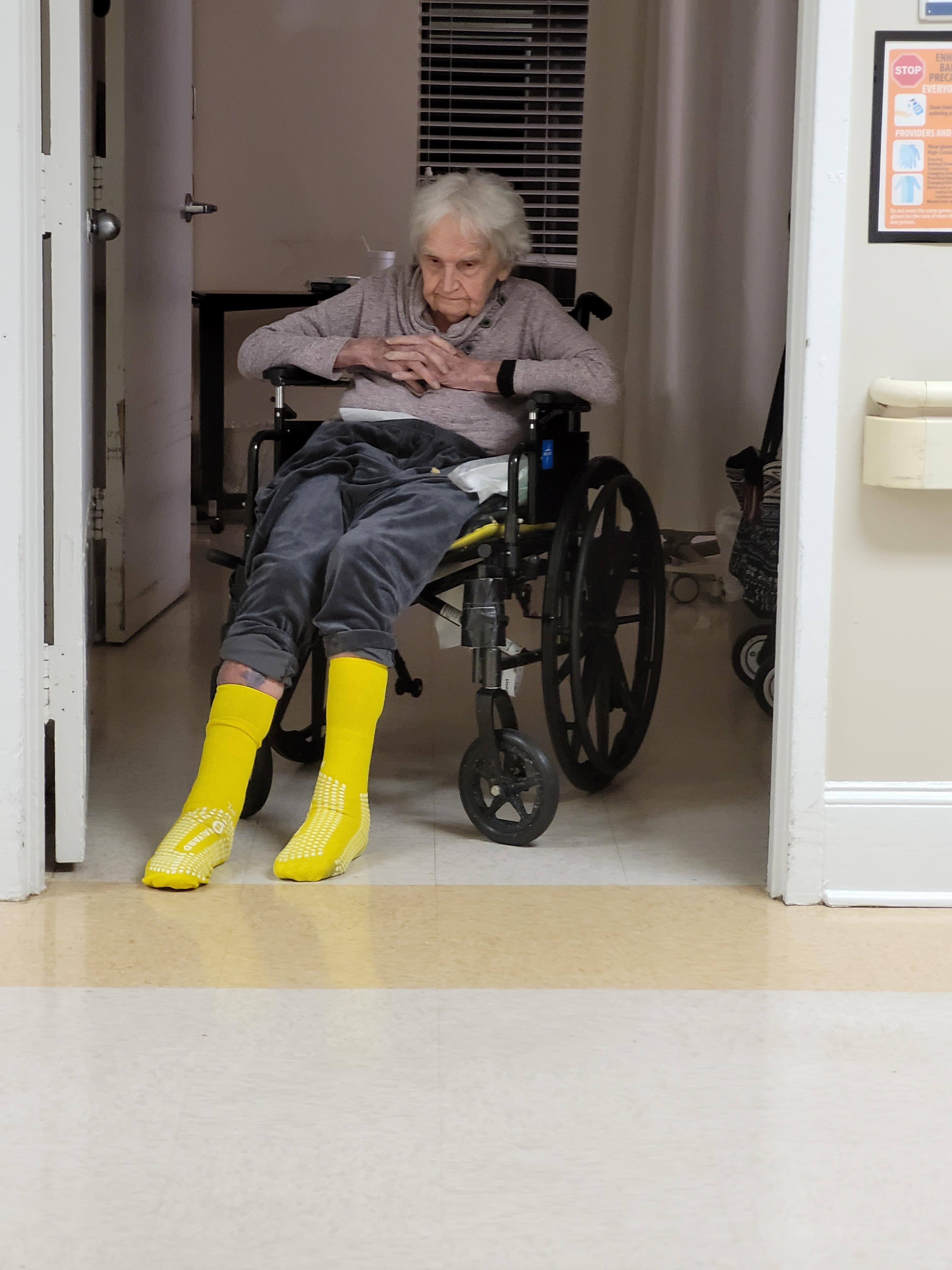 An old woman sitting in a wheelchair