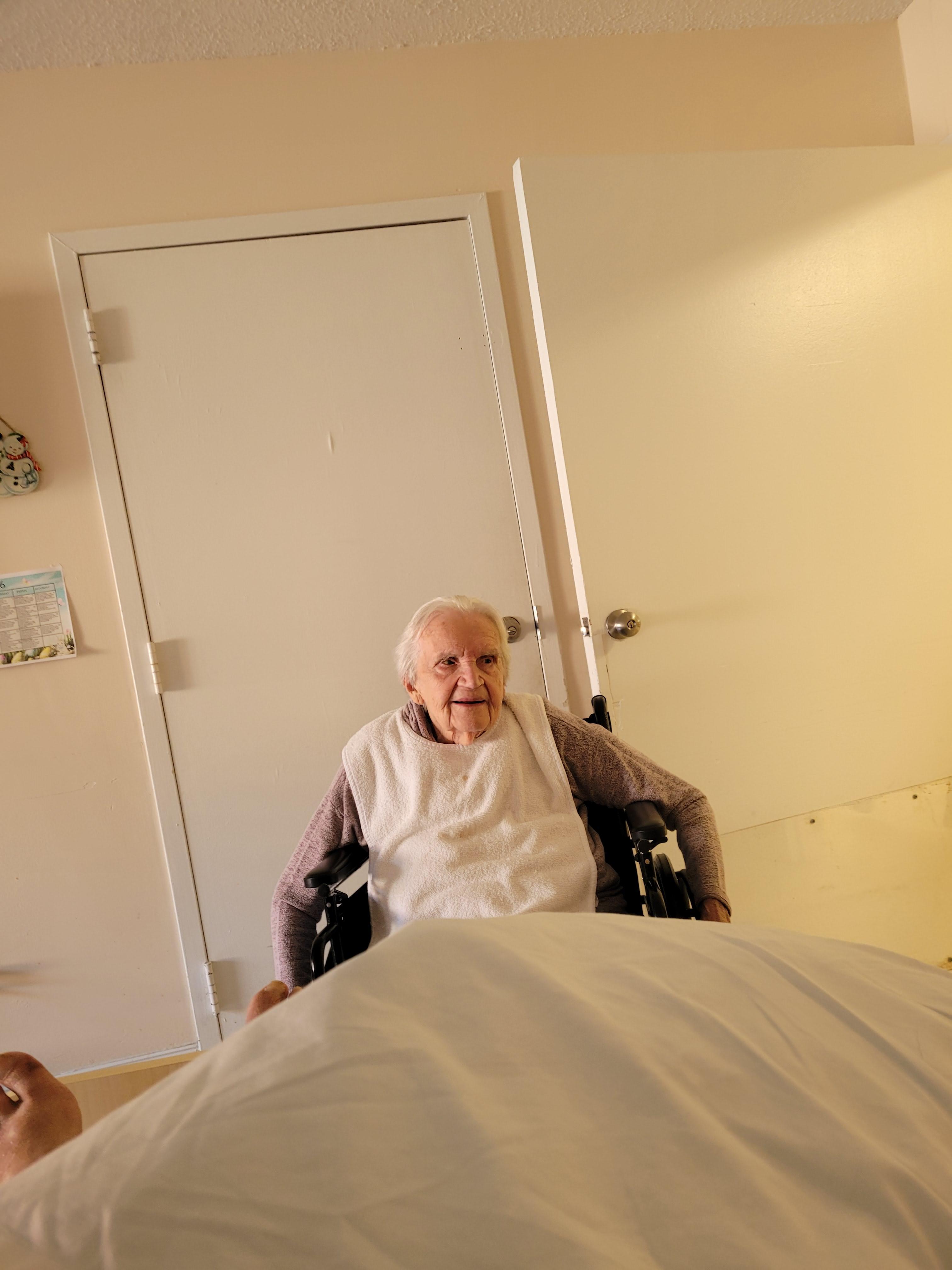 An elderly woman in a wheelchair