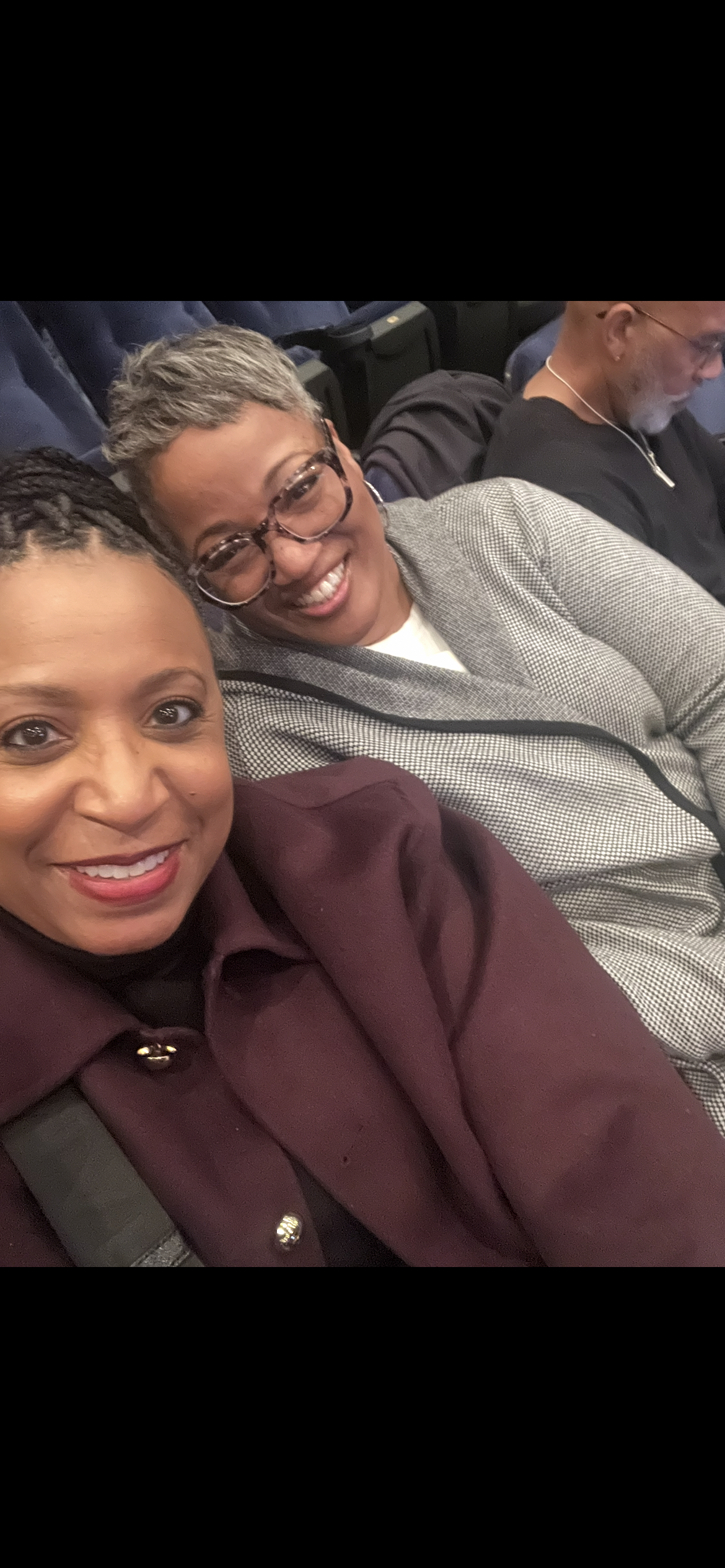 A group of women sitting together smiling