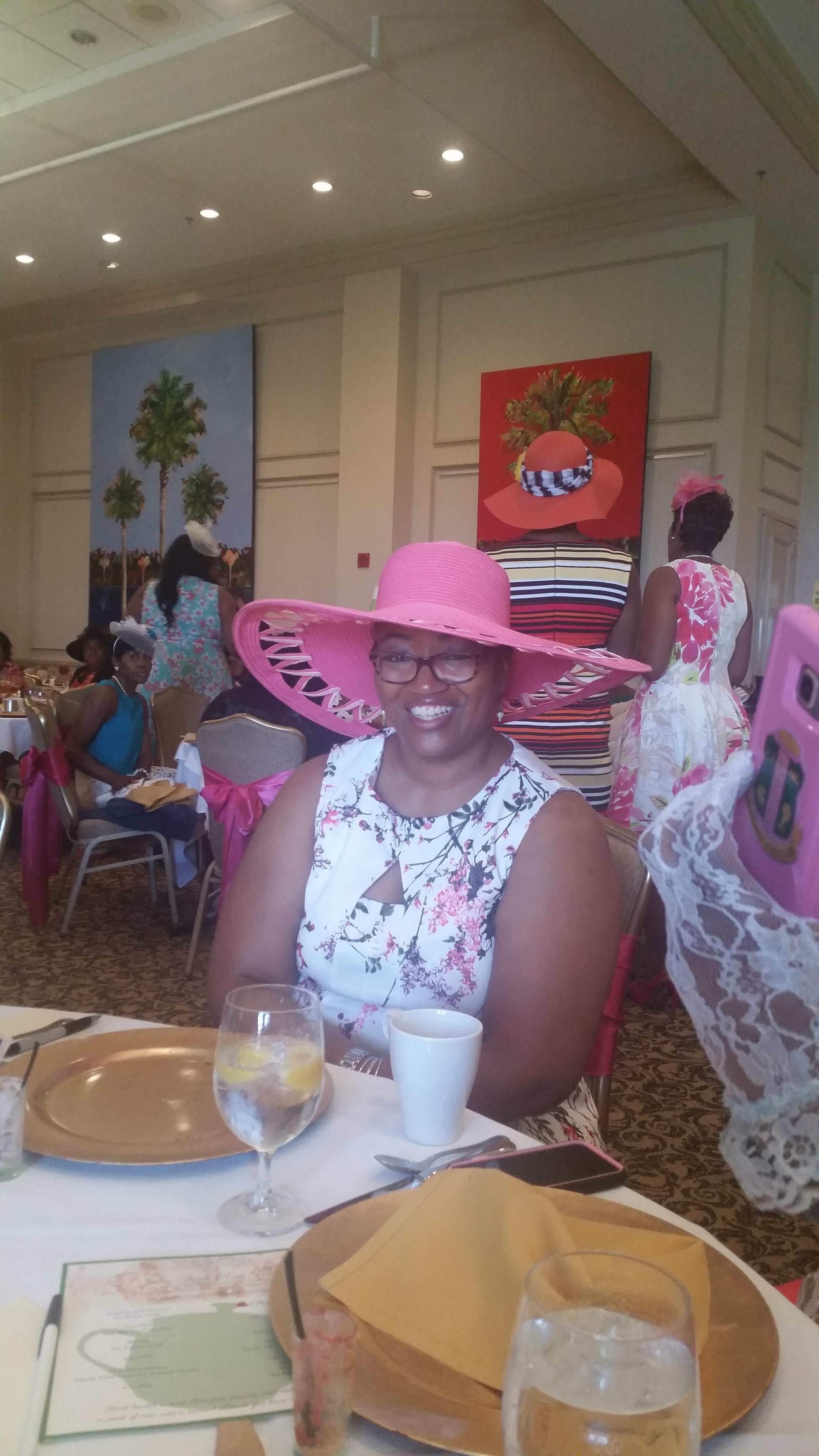 A woman wearing a pink hat and glasses