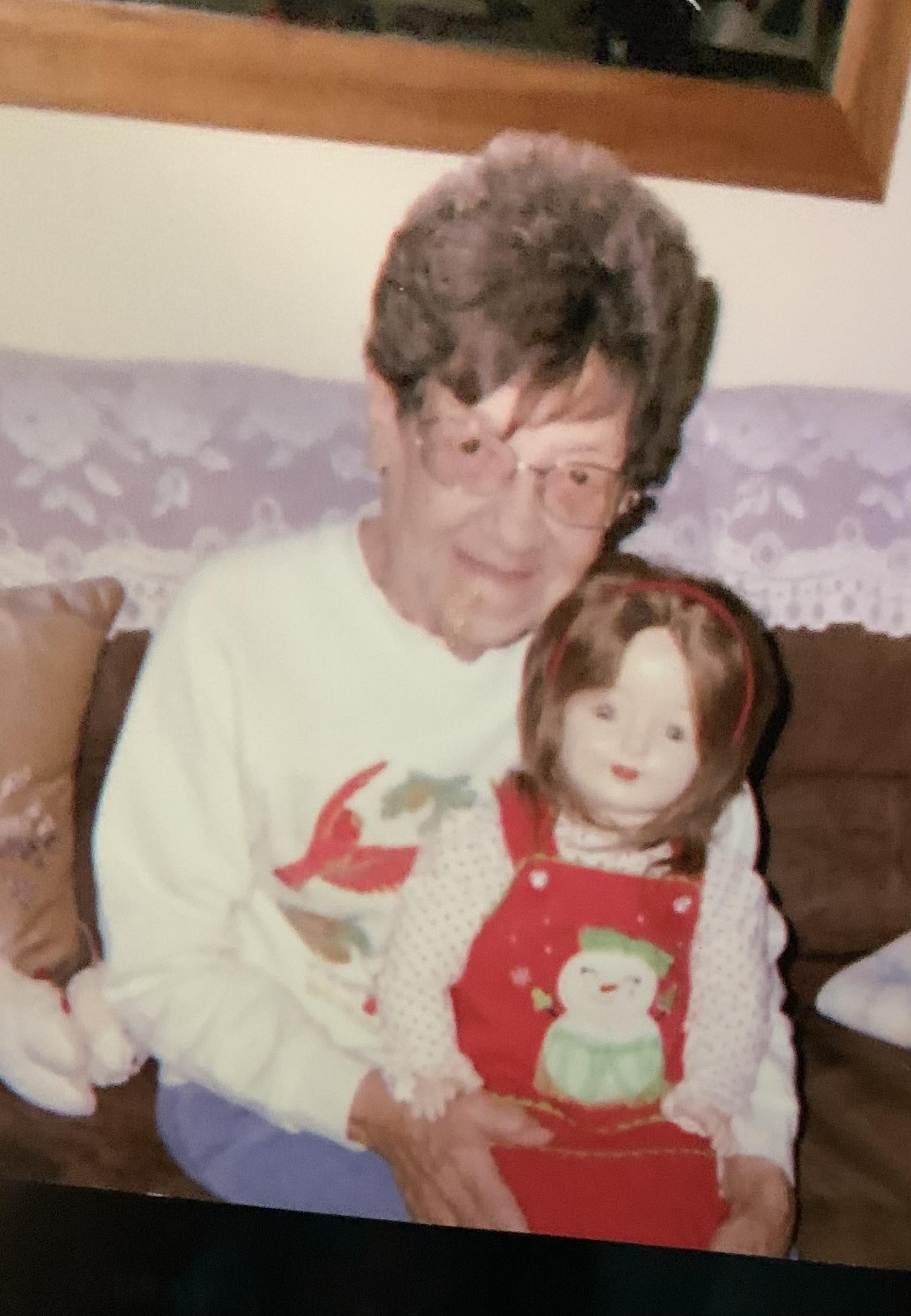 An old woman holding a doll