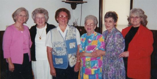 A group of older women posing for a photo