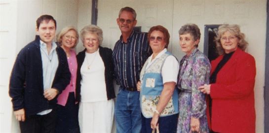 A group of older people posing for a photo