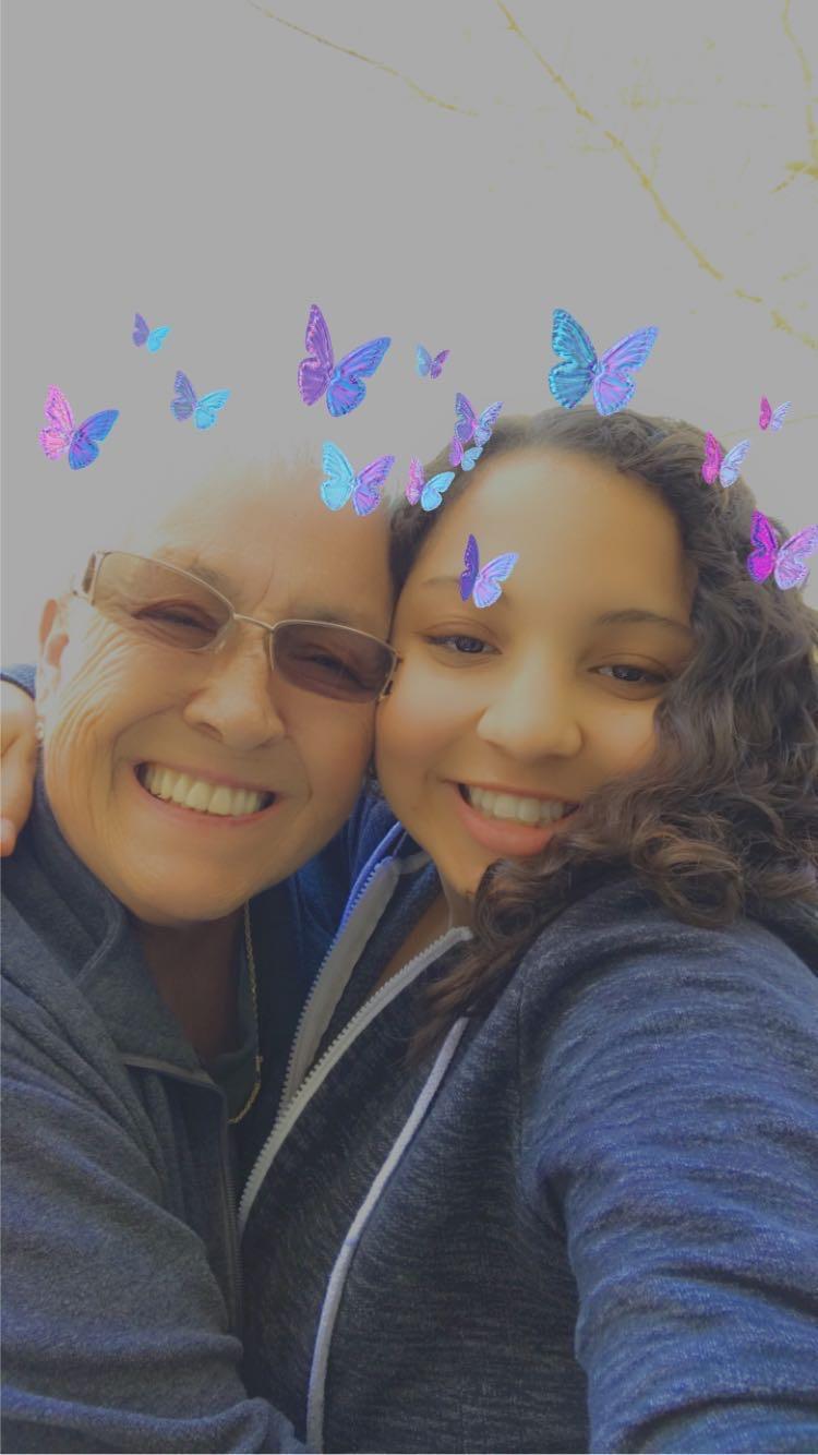 A selfie of a woman and a girl with butterflies