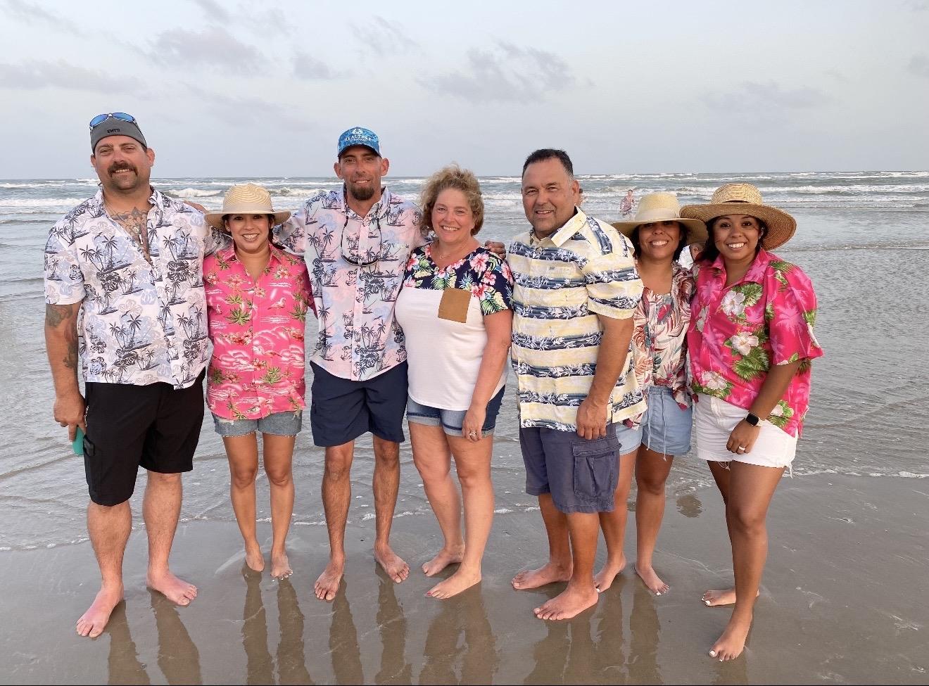 A group of people standing on a beach