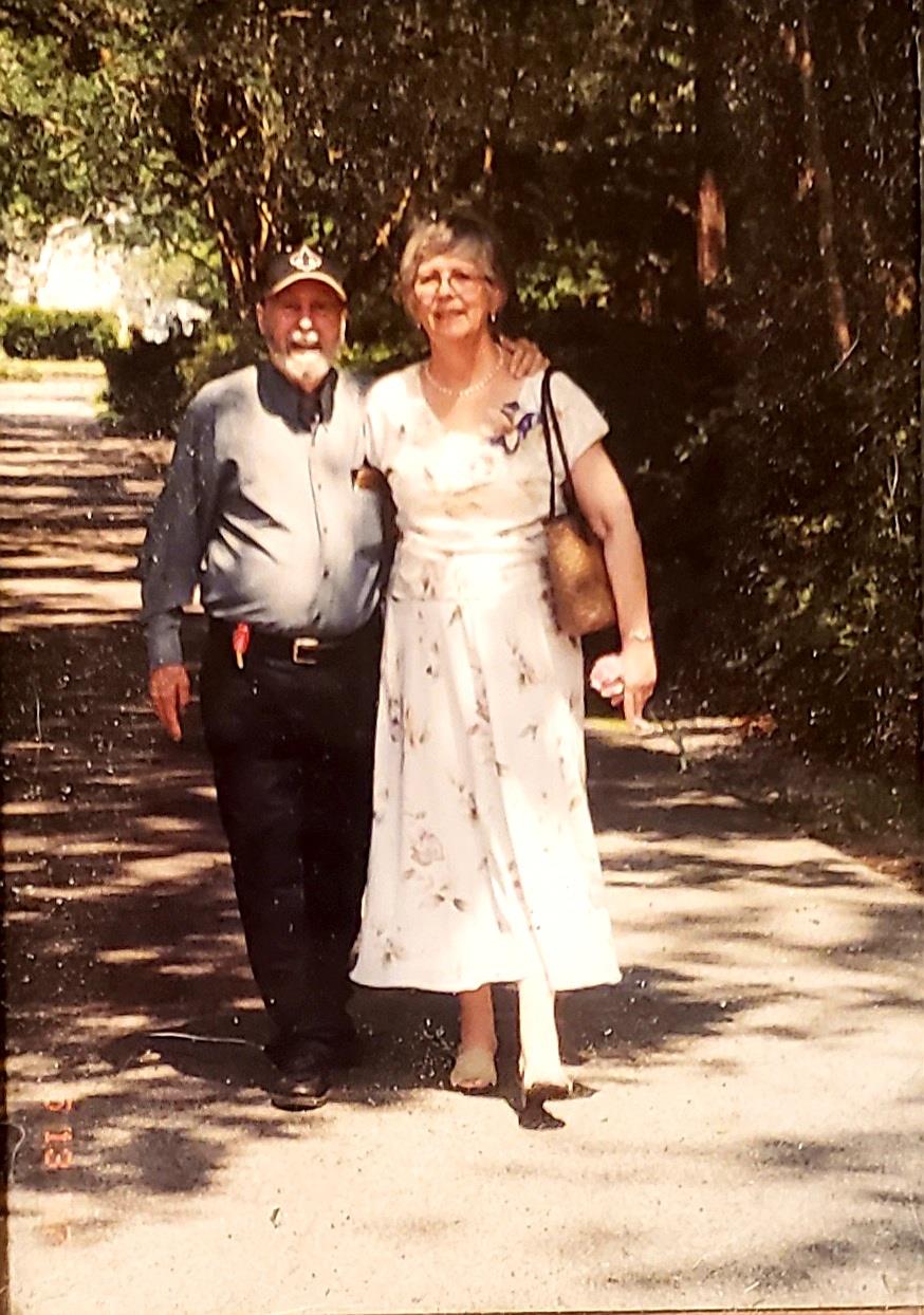 A man and woman standing on a path