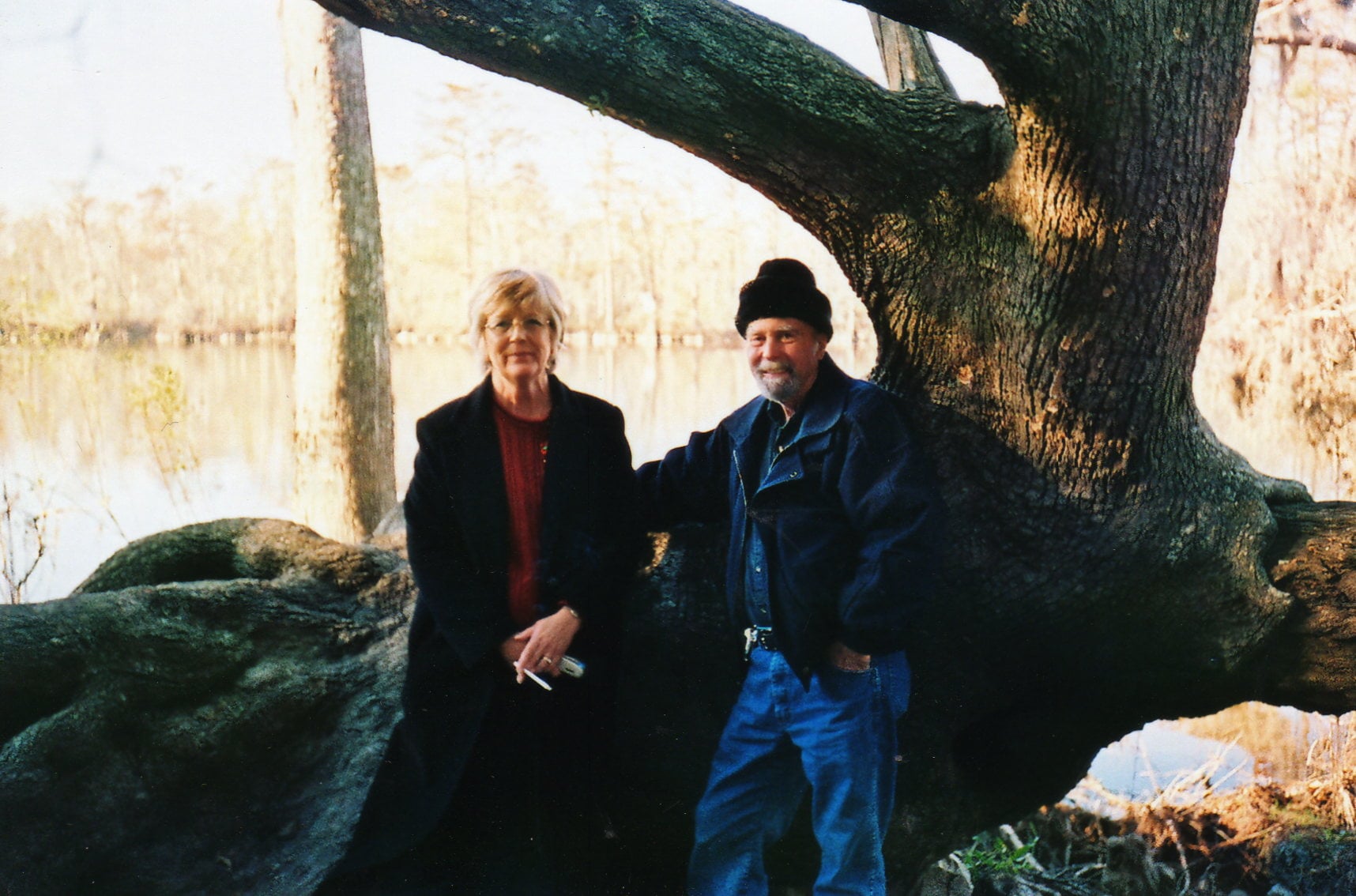 A man and woman standing under a tree