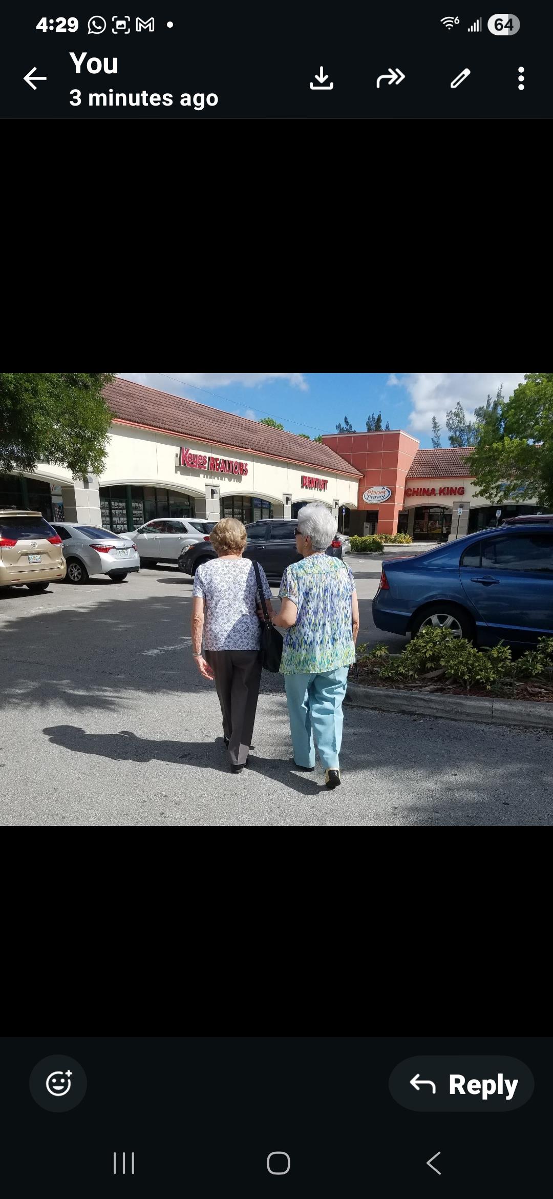 Two women walking in a parking lot
