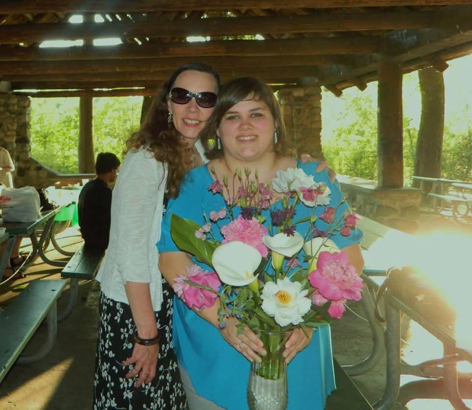 A woman holding a bouquet of flowers
