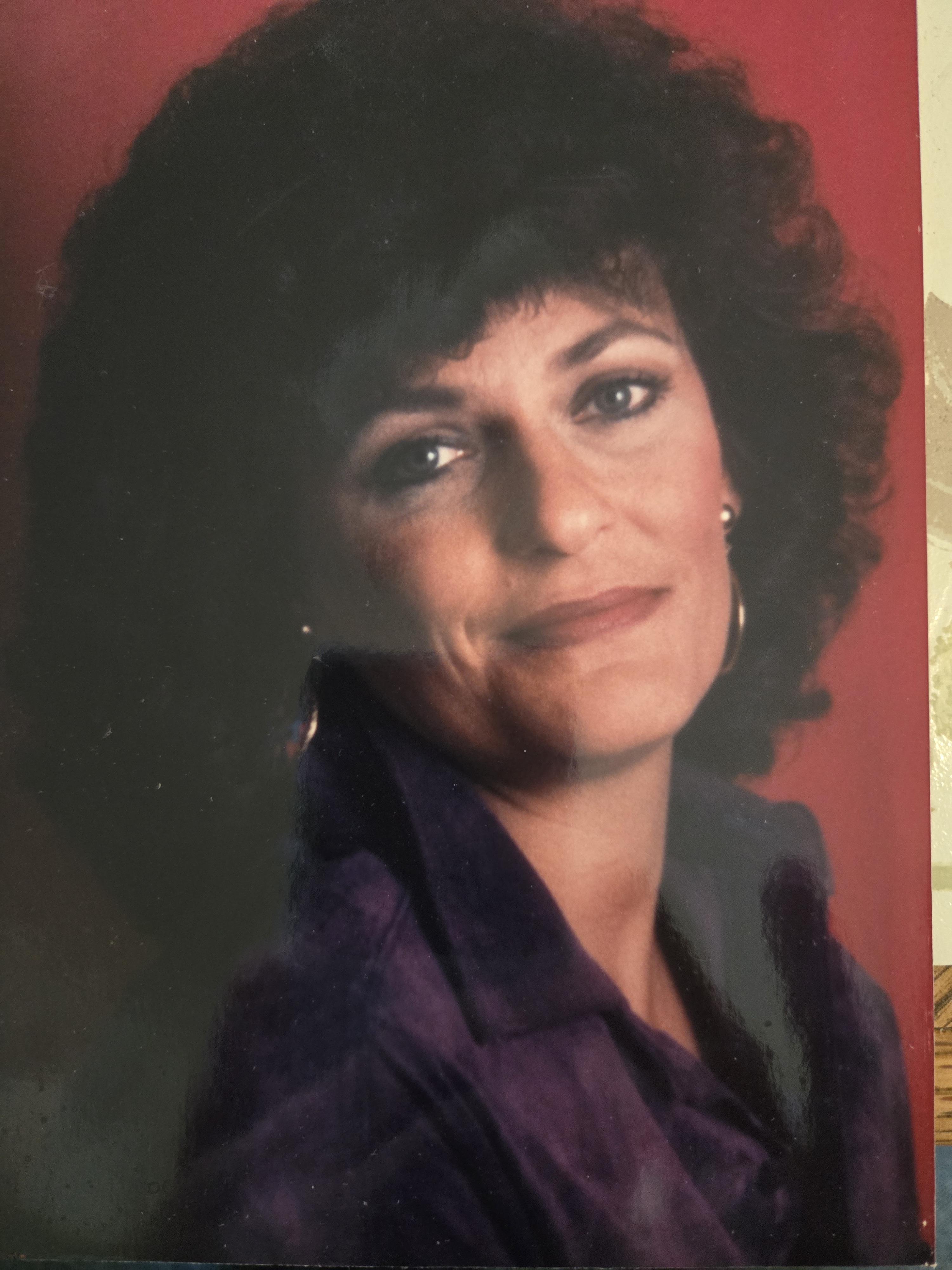 A woman with curly hair smiling