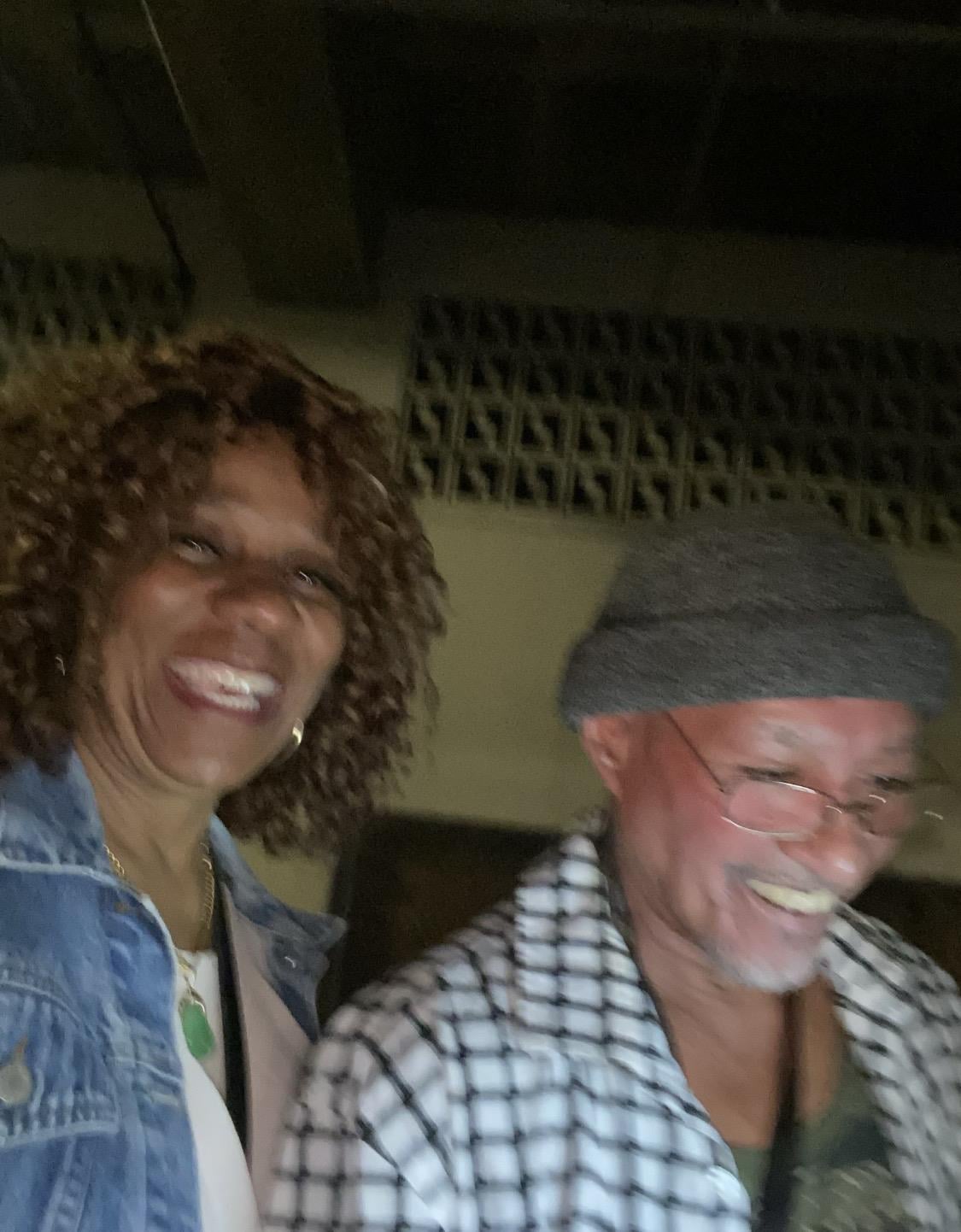 A man and woman smiling at the camera