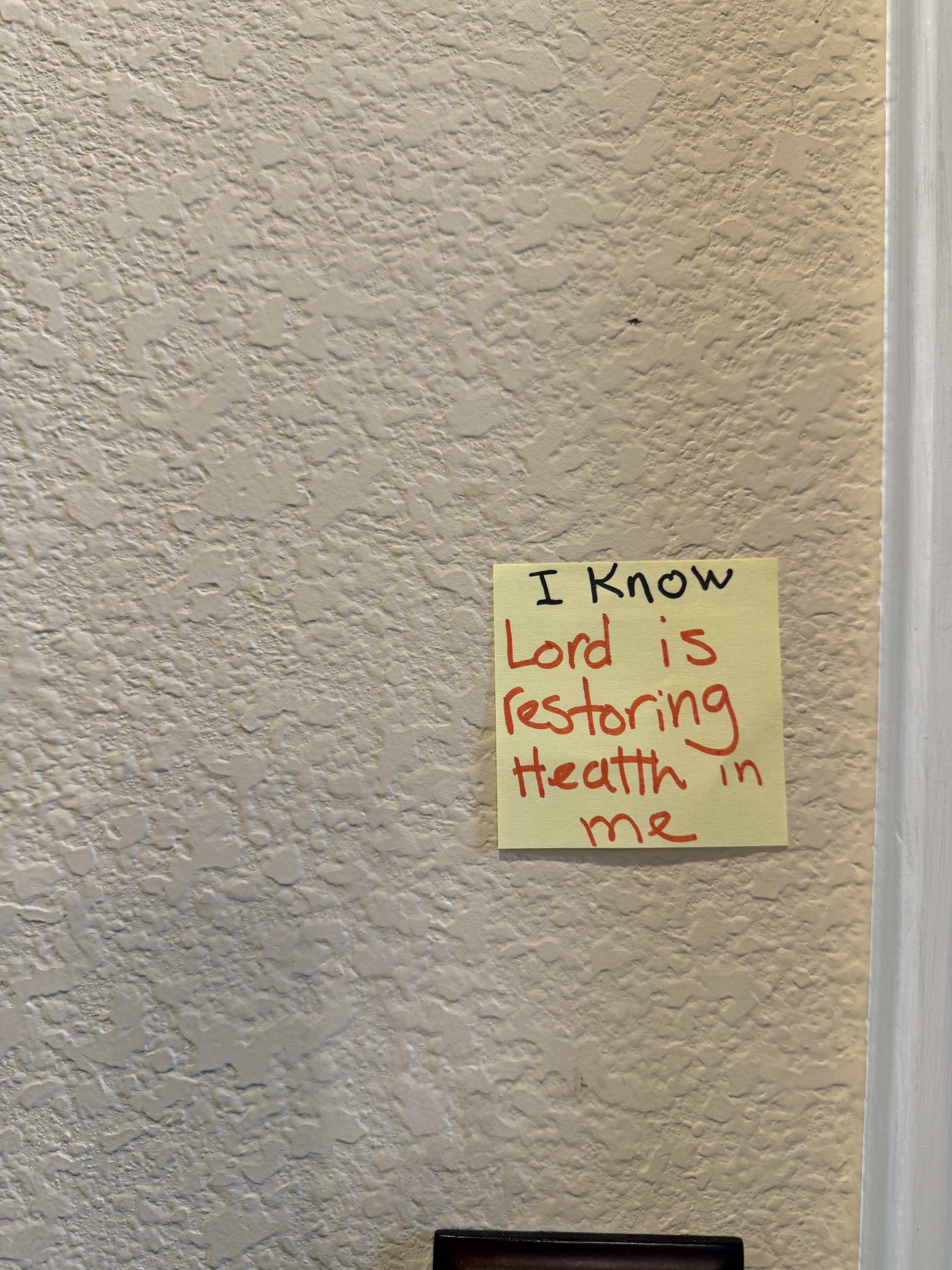 A yellow note on a wall