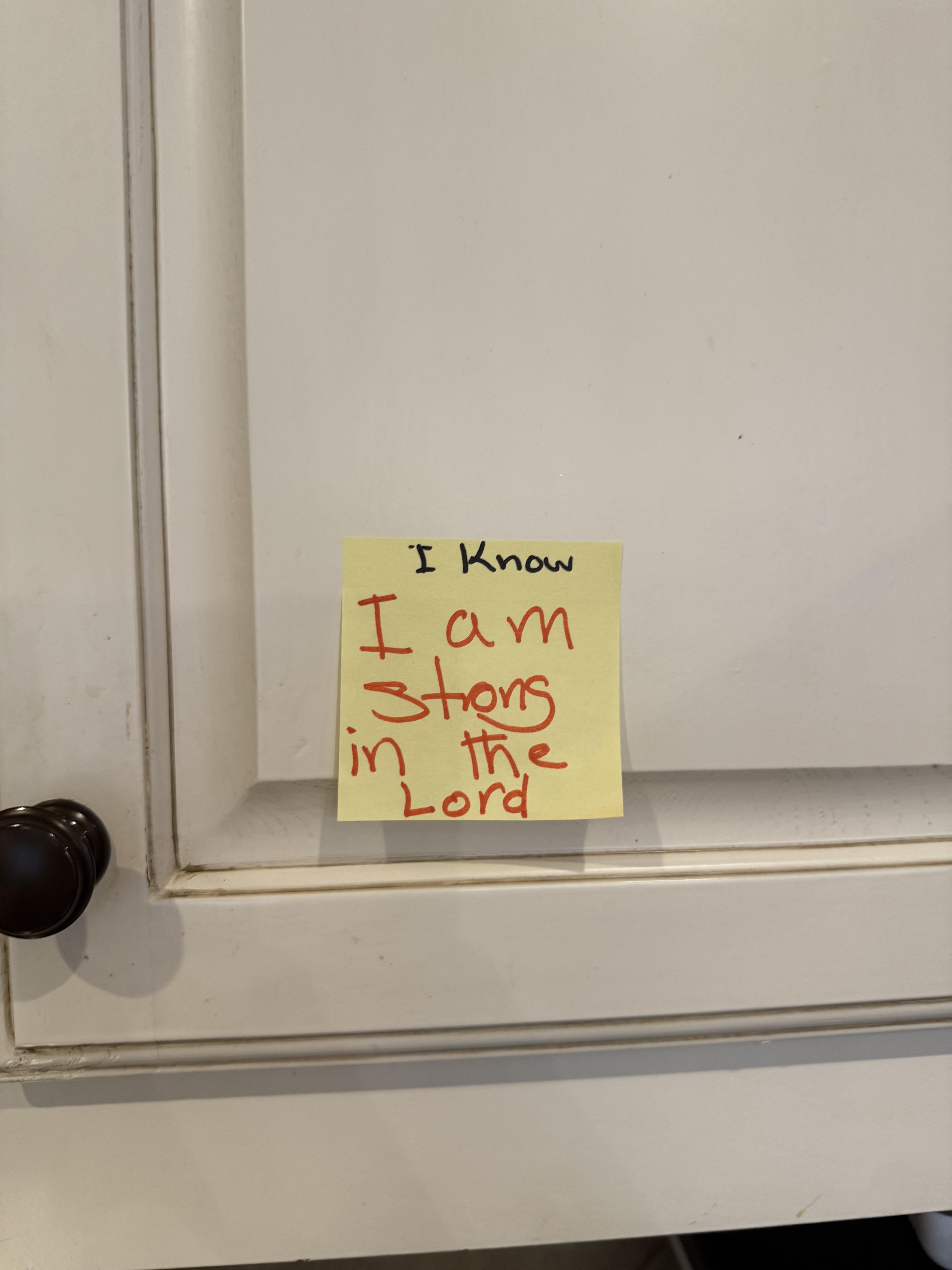 A yellow note on a door